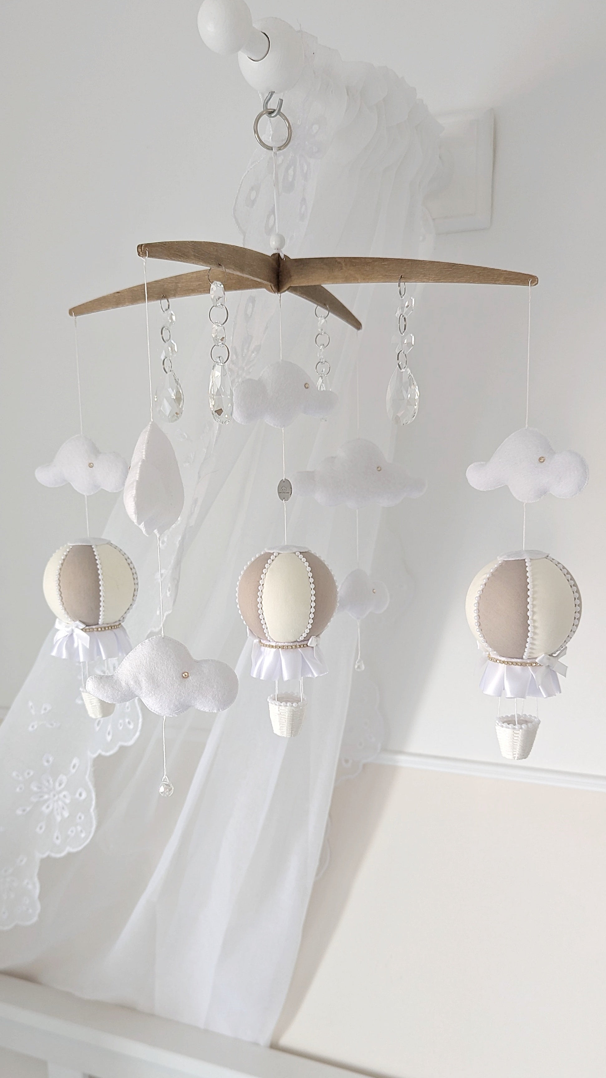 Complete nursery set with coordinating hot air balloon mobile and wall balloons in gentle ivory and taupe.