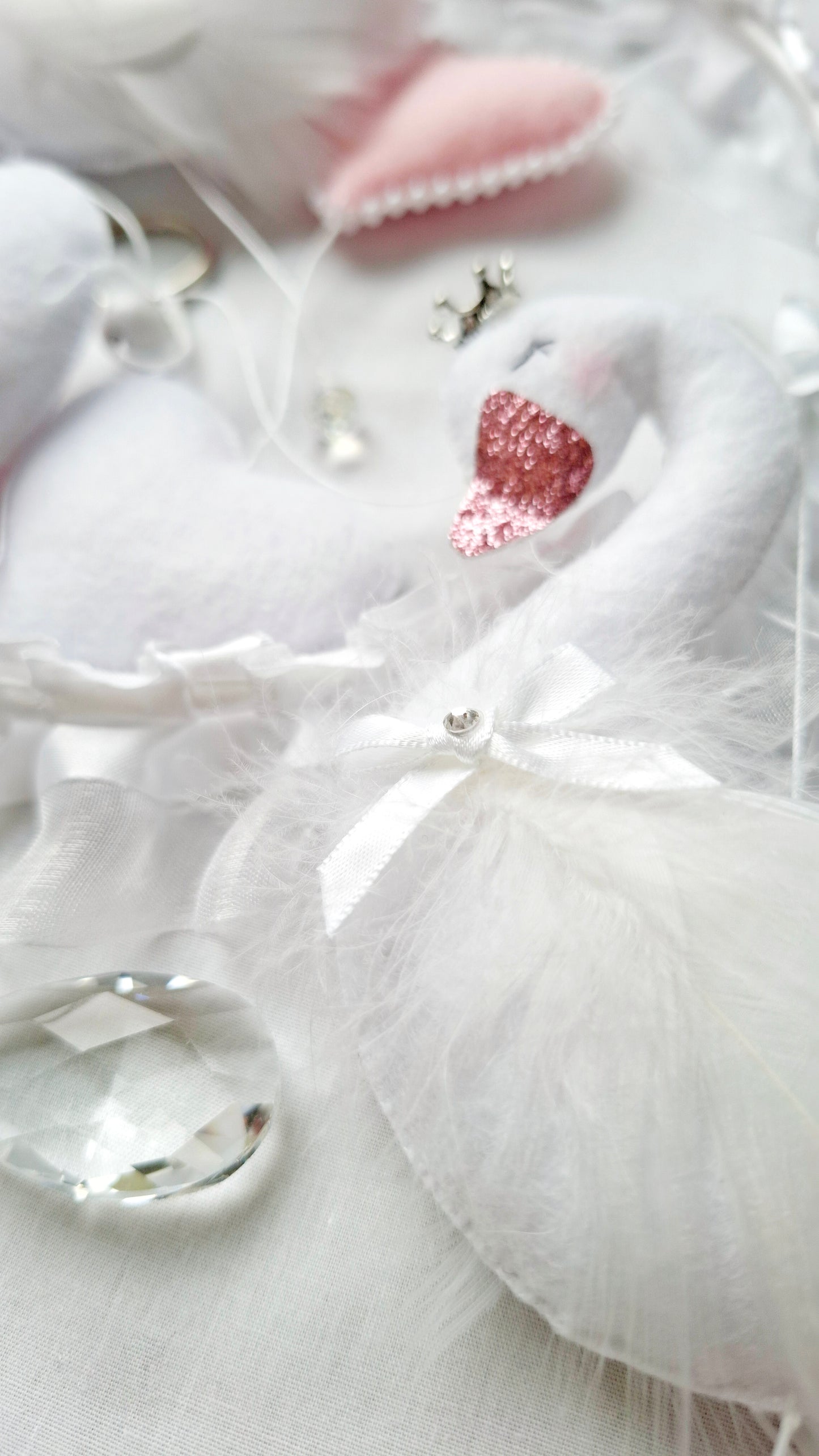 Close-up flat lay of crystal accents from a dreamy handmade baby mobile, pure elegance in every detail.