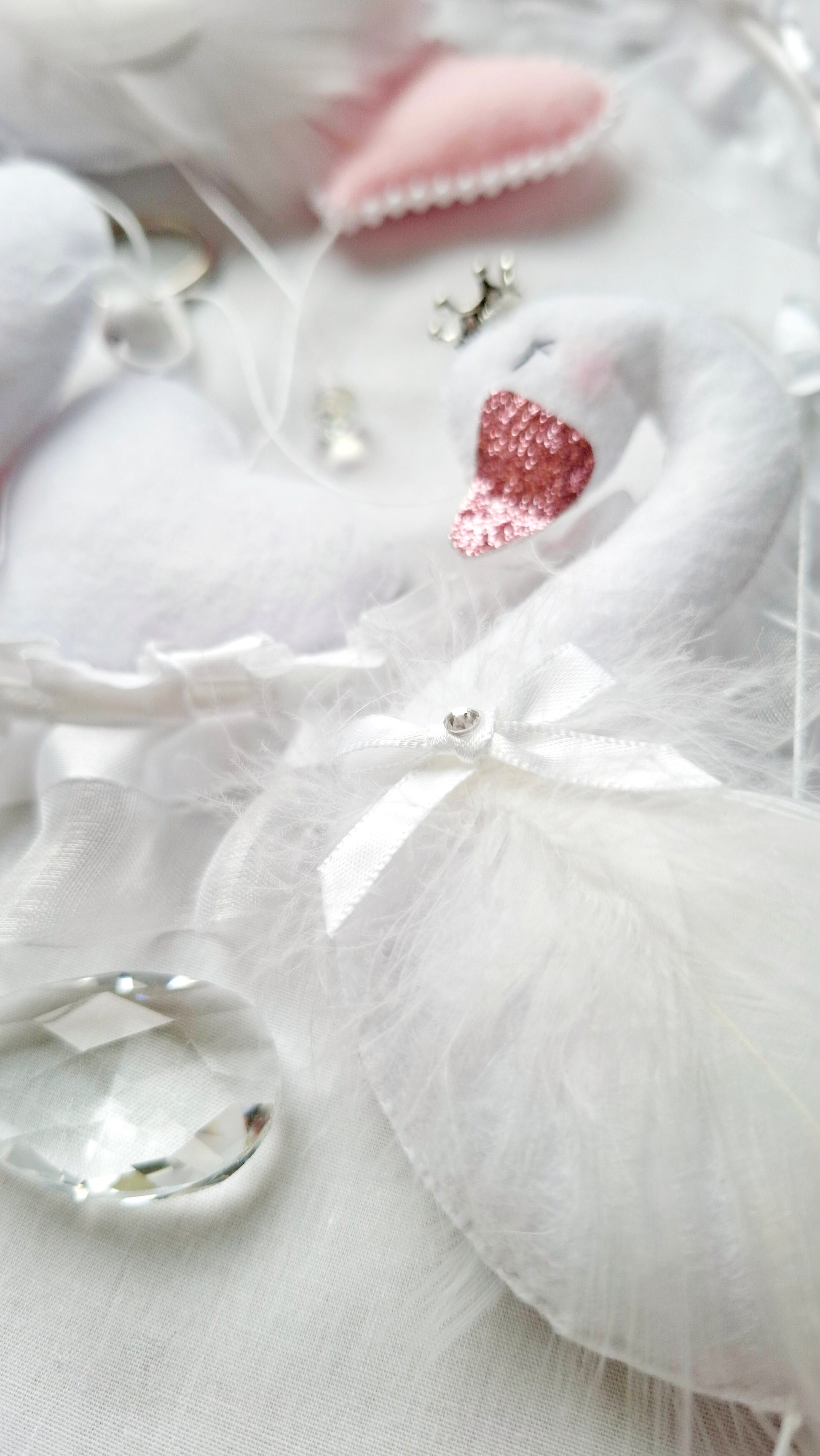 Close-up flat lay of crystal accents from a dreamy handmade baby mobile, pure elegance in every detail.