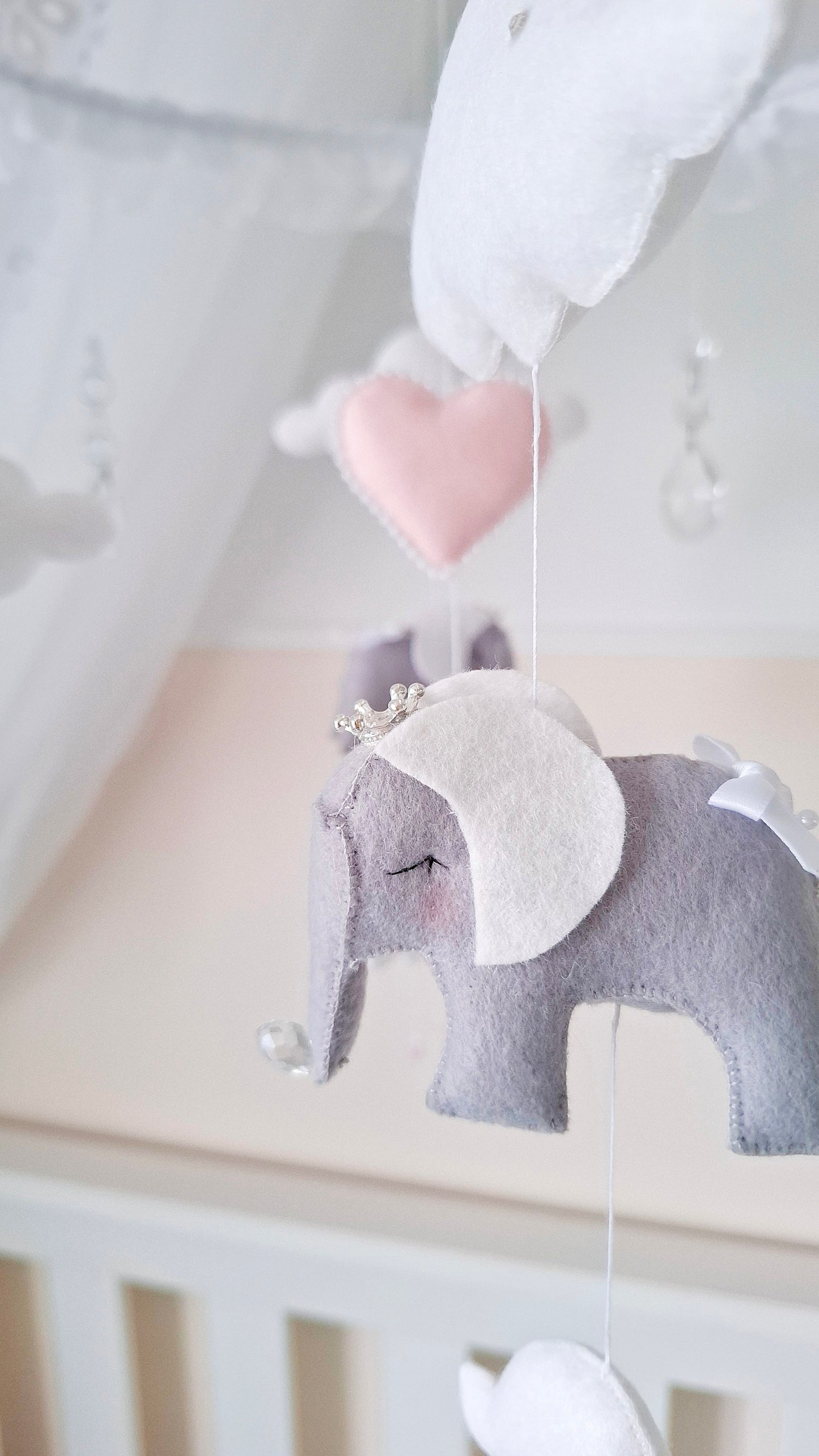 Fairy tale baby mobile with gentle pink and white tones, perfect for an enchanting nursery full of softness and charm.