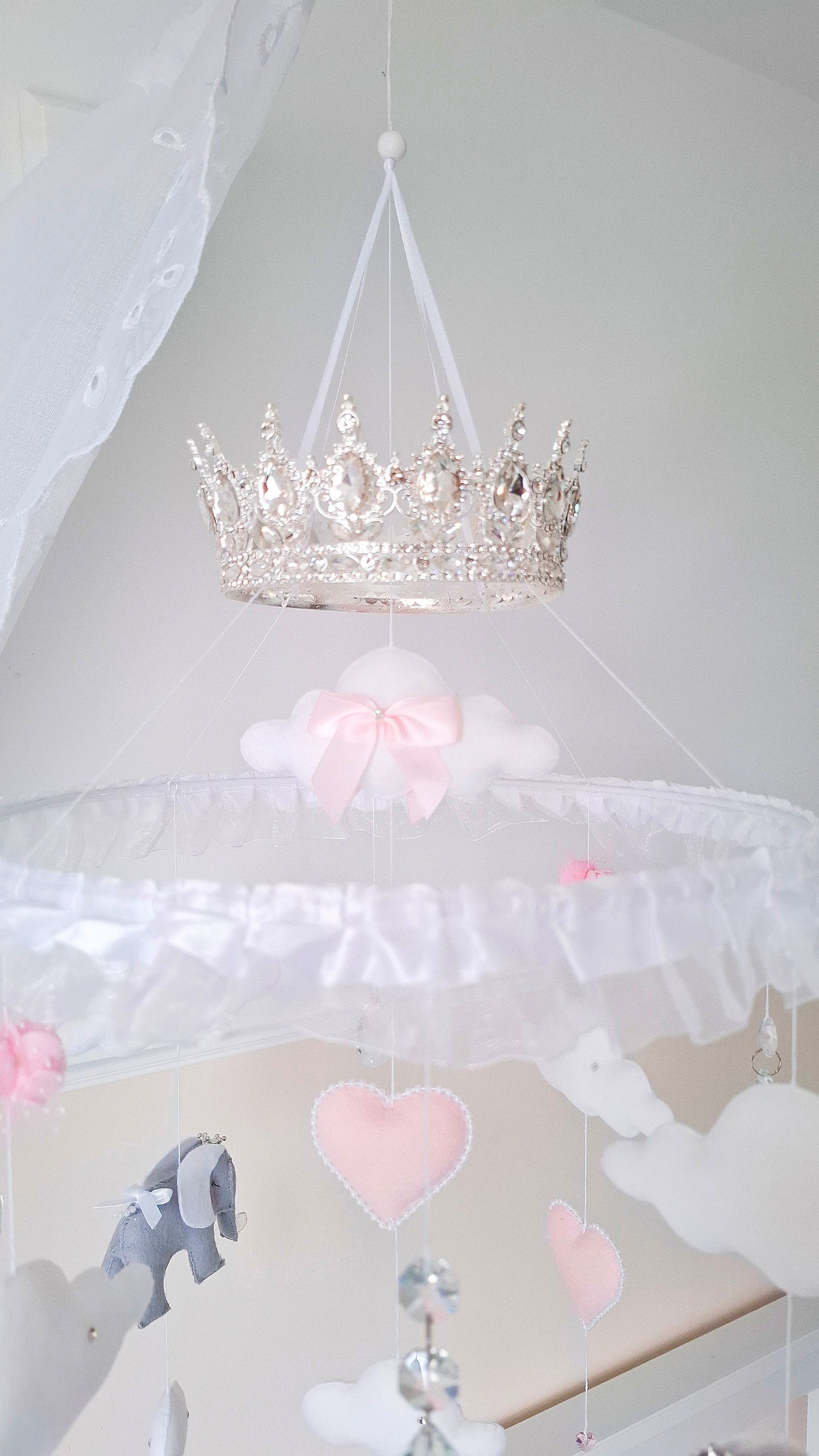 Handmade baby mobile with silver crown hanger, pink hearts, grey felt elephants, and crystal drops for sparkle.