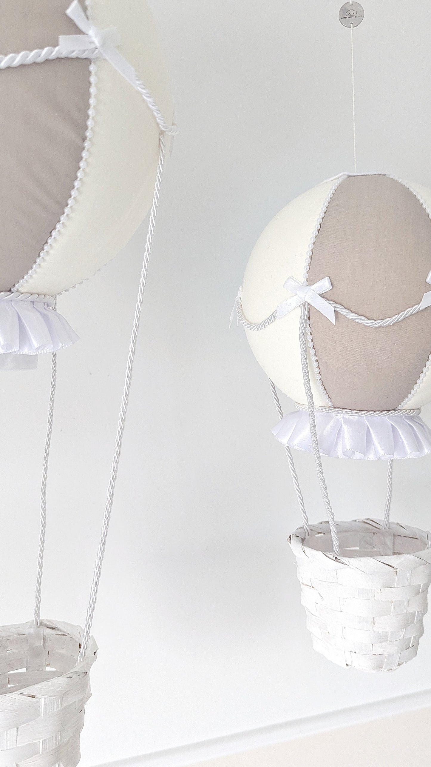 Elegant large hot air balloon in ivory and taupe with pearl trim, satin frills and a soft white basket.