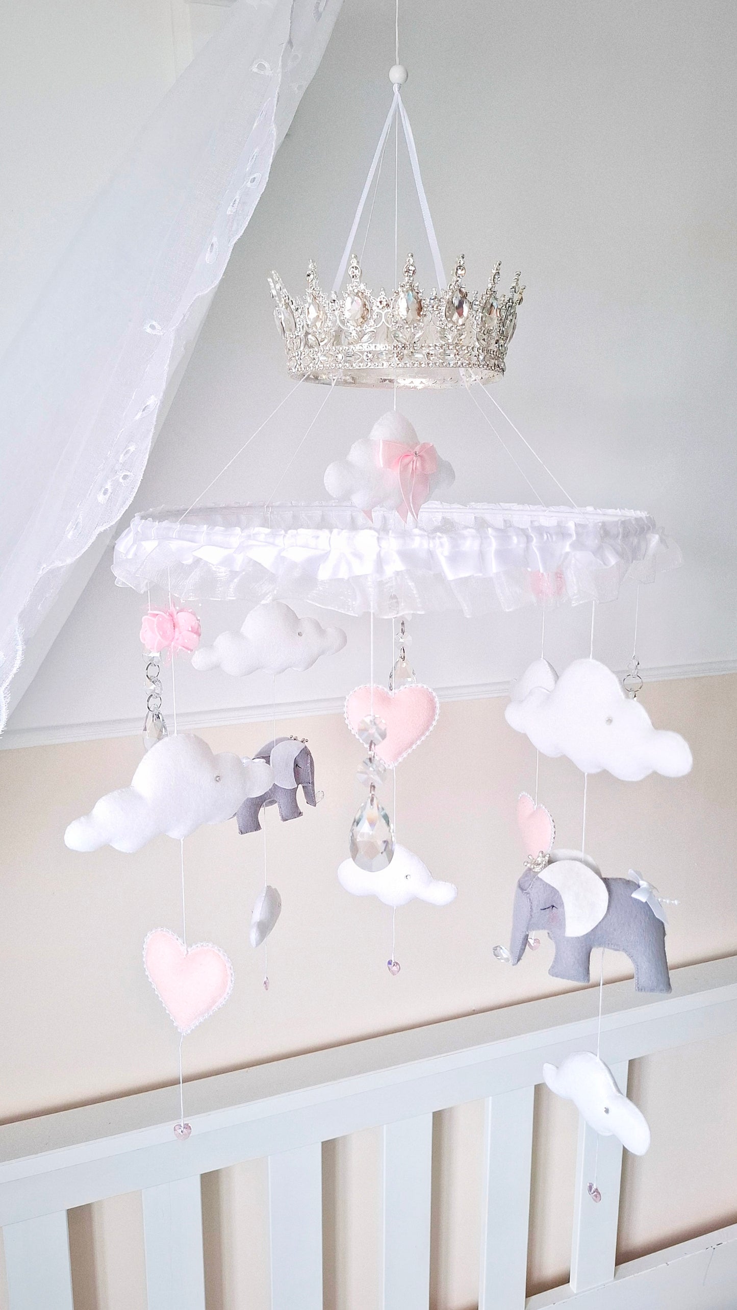 Luxury baby mobile with a silver crown, soft felt elephants, white clouds, and blush pink hearts—fit for a royal nursery.