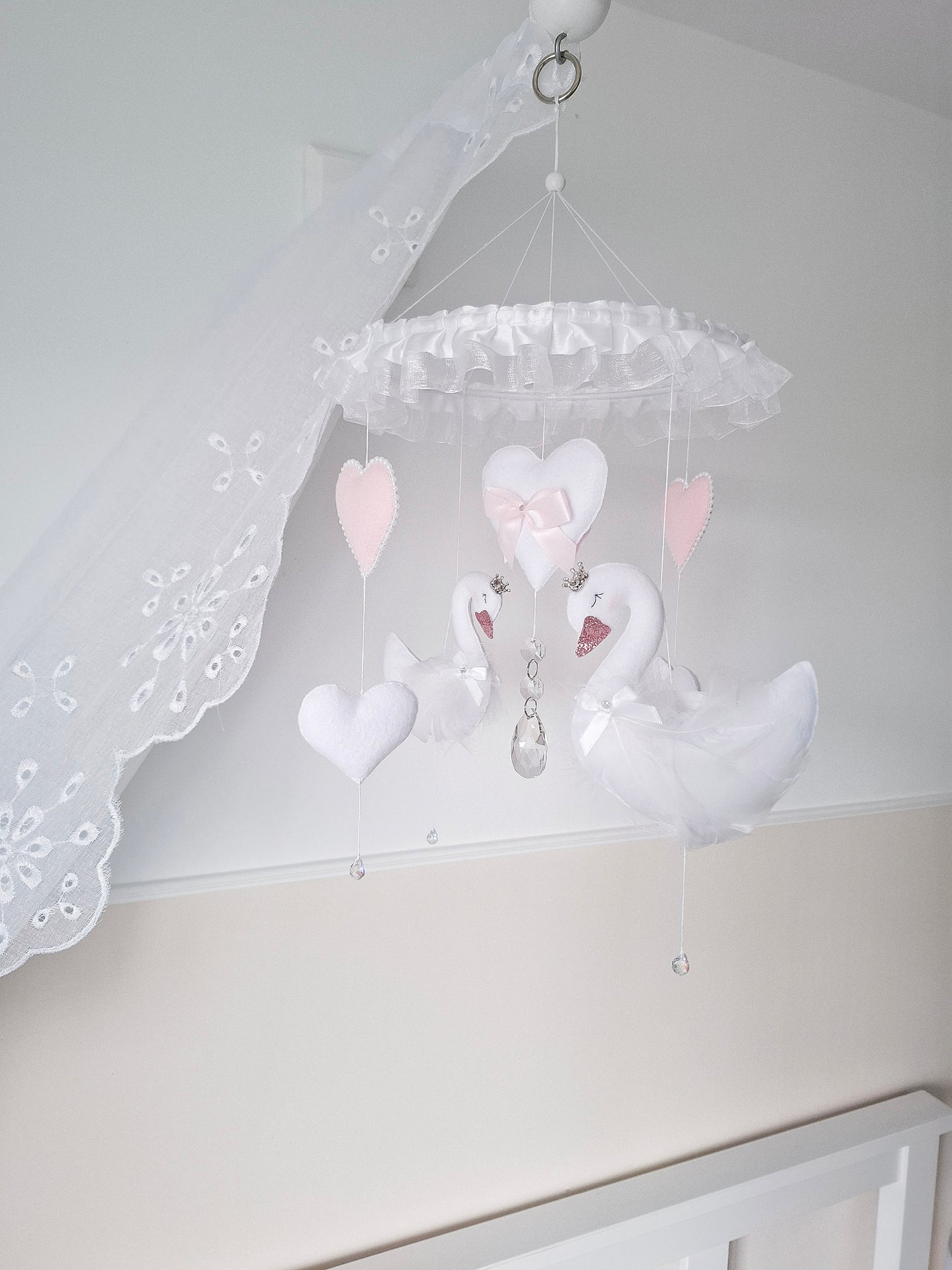 Luxury swan baby mobile in soft pink and white tones, handmade with felt swans, hearts, and crystal touches for a dreamy nursery centrepiece.