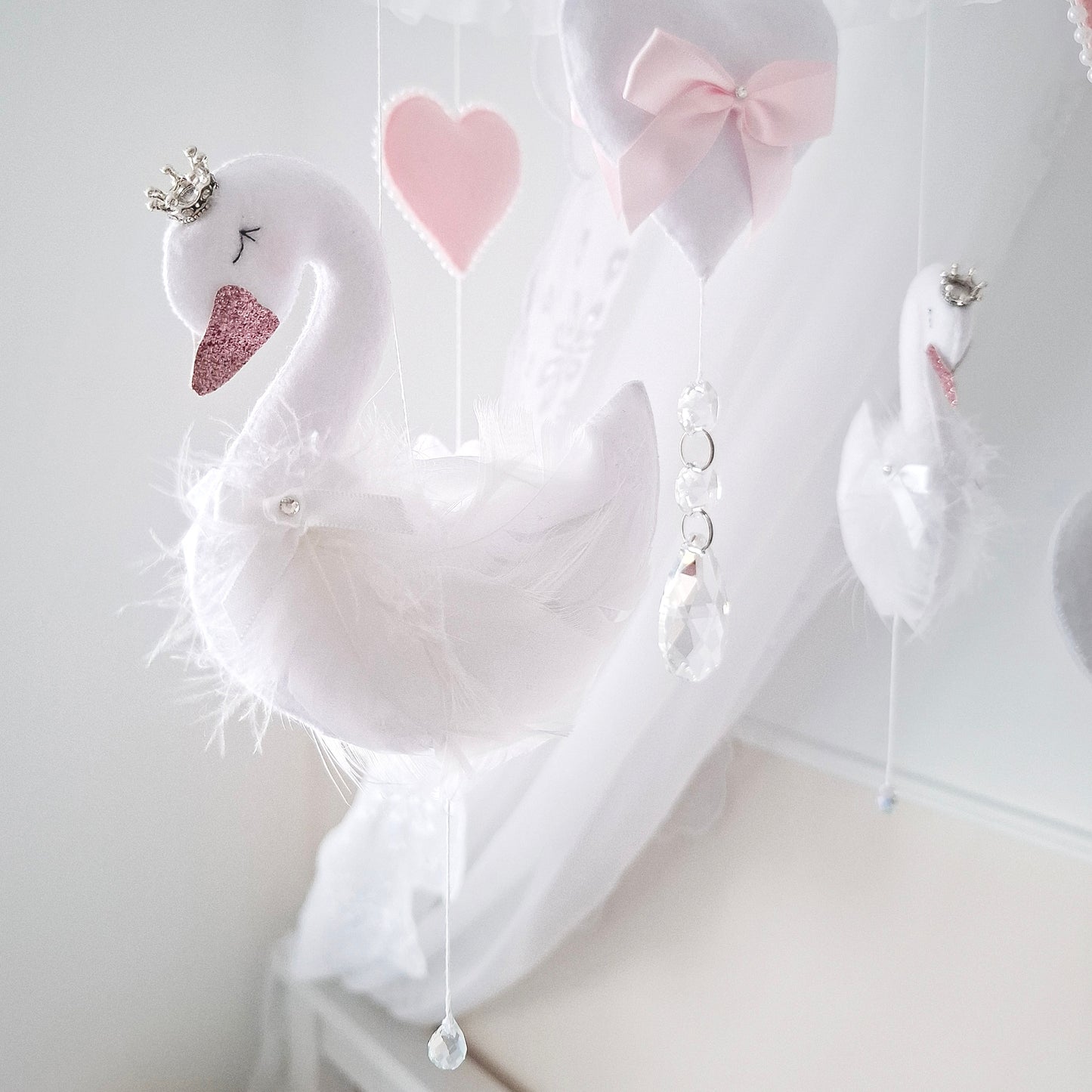 Delicate swans with soft feathered wings and sparkling crowns, handcrafted for a magical, elegant baby girl mobile.