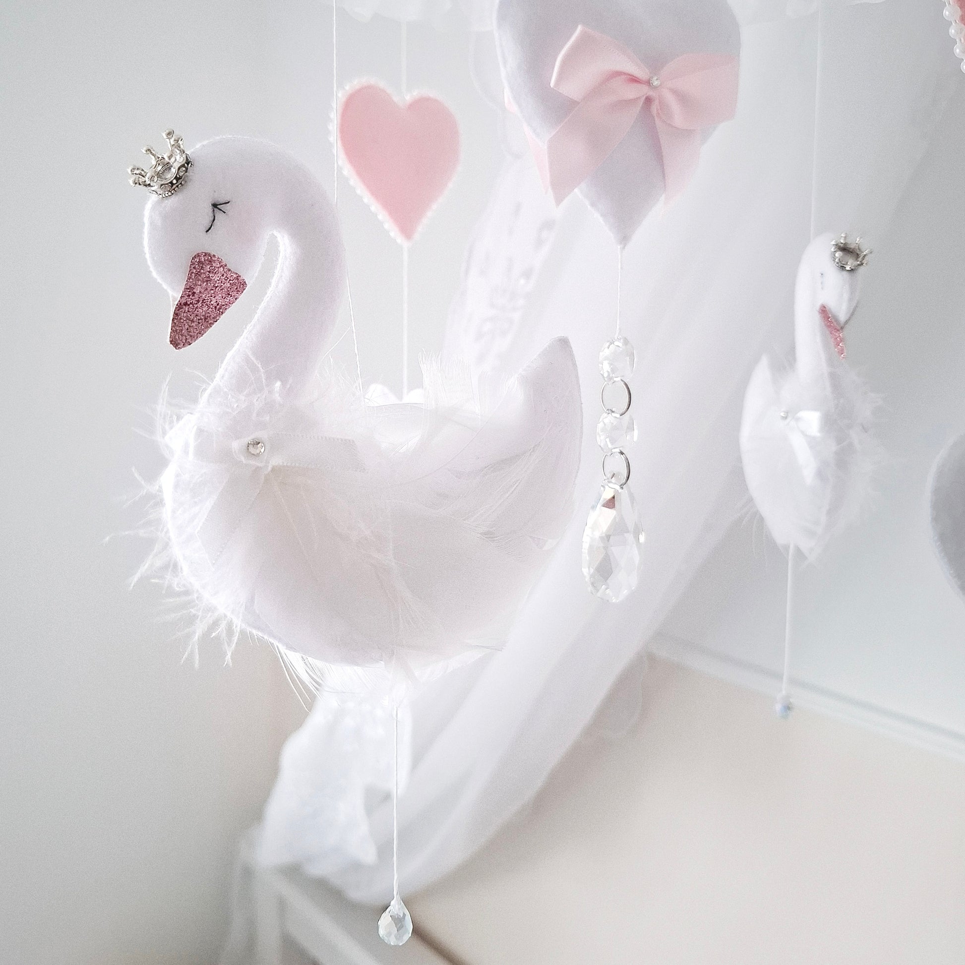 Delicate swans with soft feathered wings and sparkling crowns, handcrafted for a magical, elegant baby girl mobile.