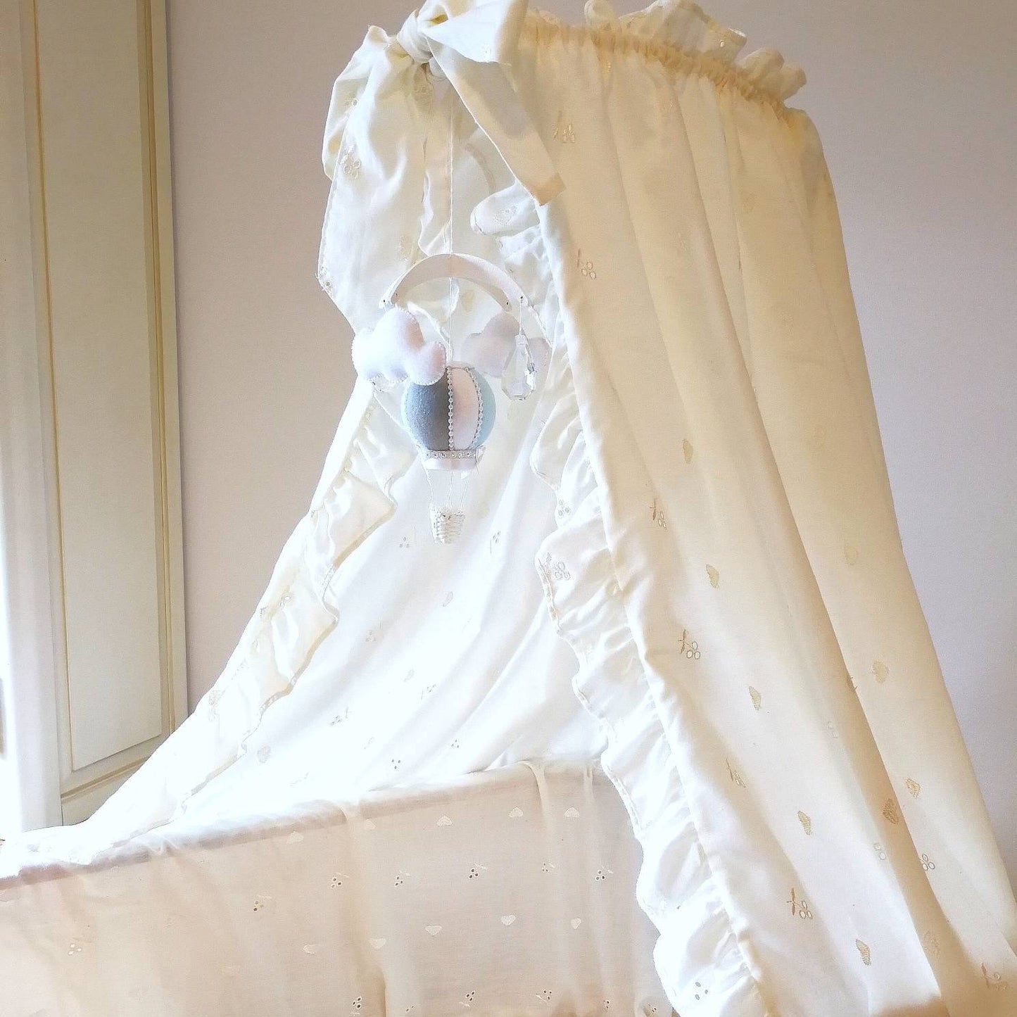 Elegant miniature hot air balloon baby mobile in soft blue and ivory, handmade for moses baskets and newborn photography props