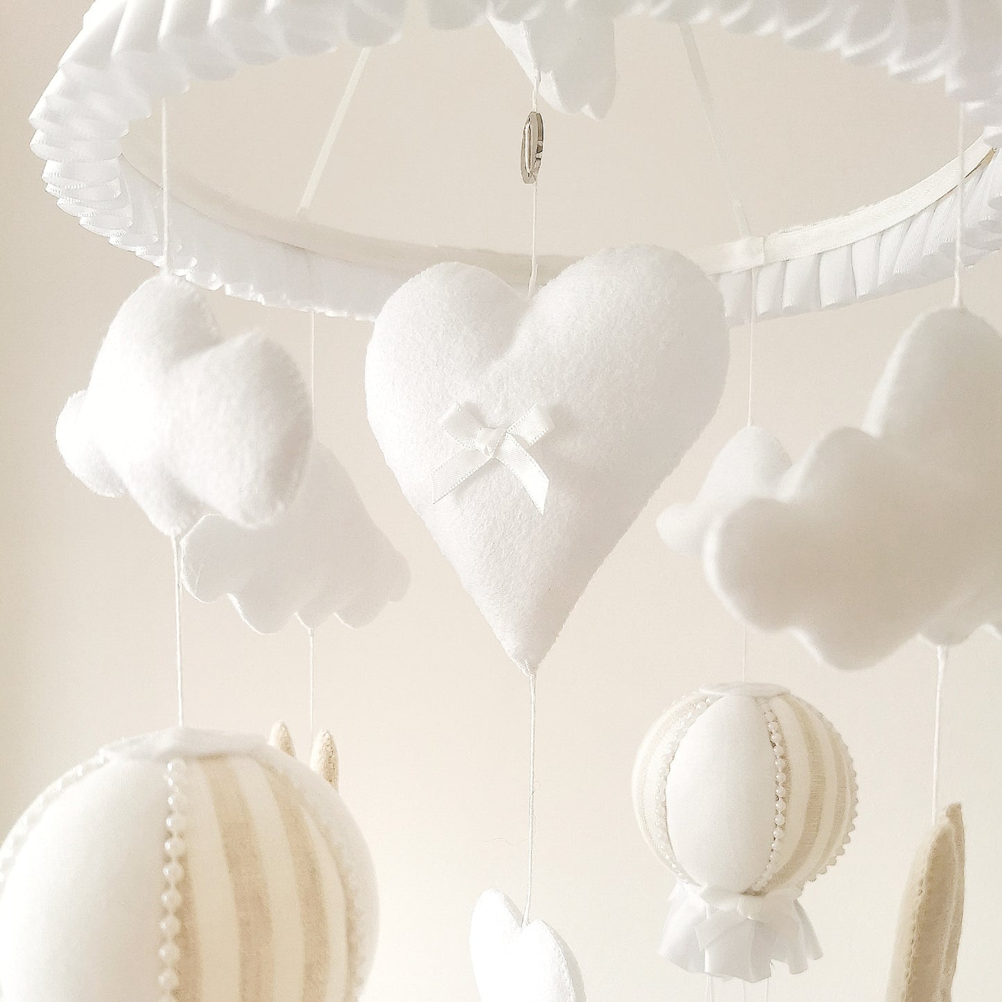 Elegant nursery mobile featuring a soothing mix of soft clouds, beige bunnies, and delicate hot air balloons.