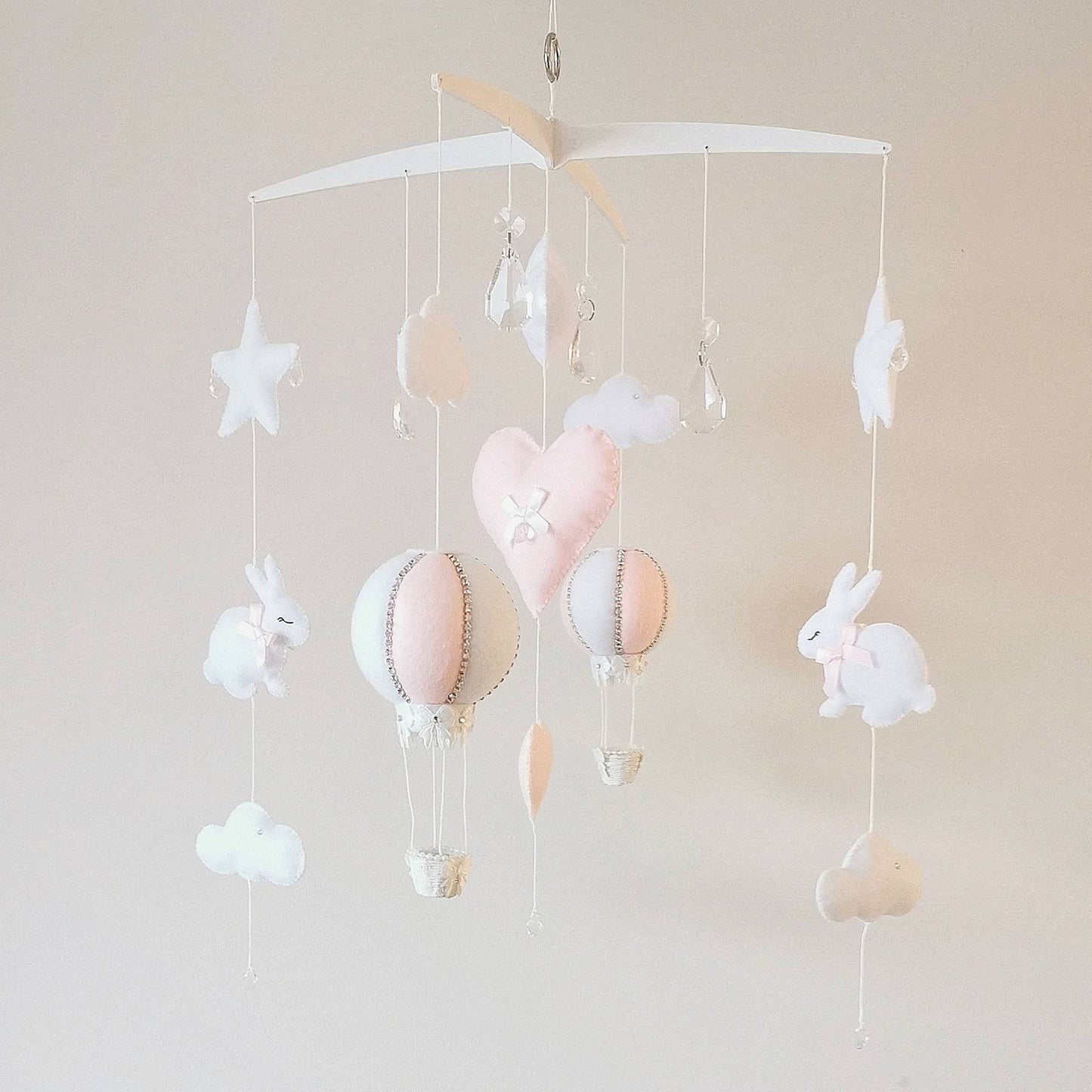 Heirloom-quality baby mobile for girls featuring a bunny, hot air balloon, and pastel felt hearts.