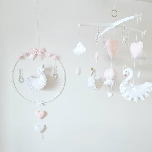 Heirloom swan baby mobile with delicate florals and heart accents, perfect for a dreamy girl's nursery.