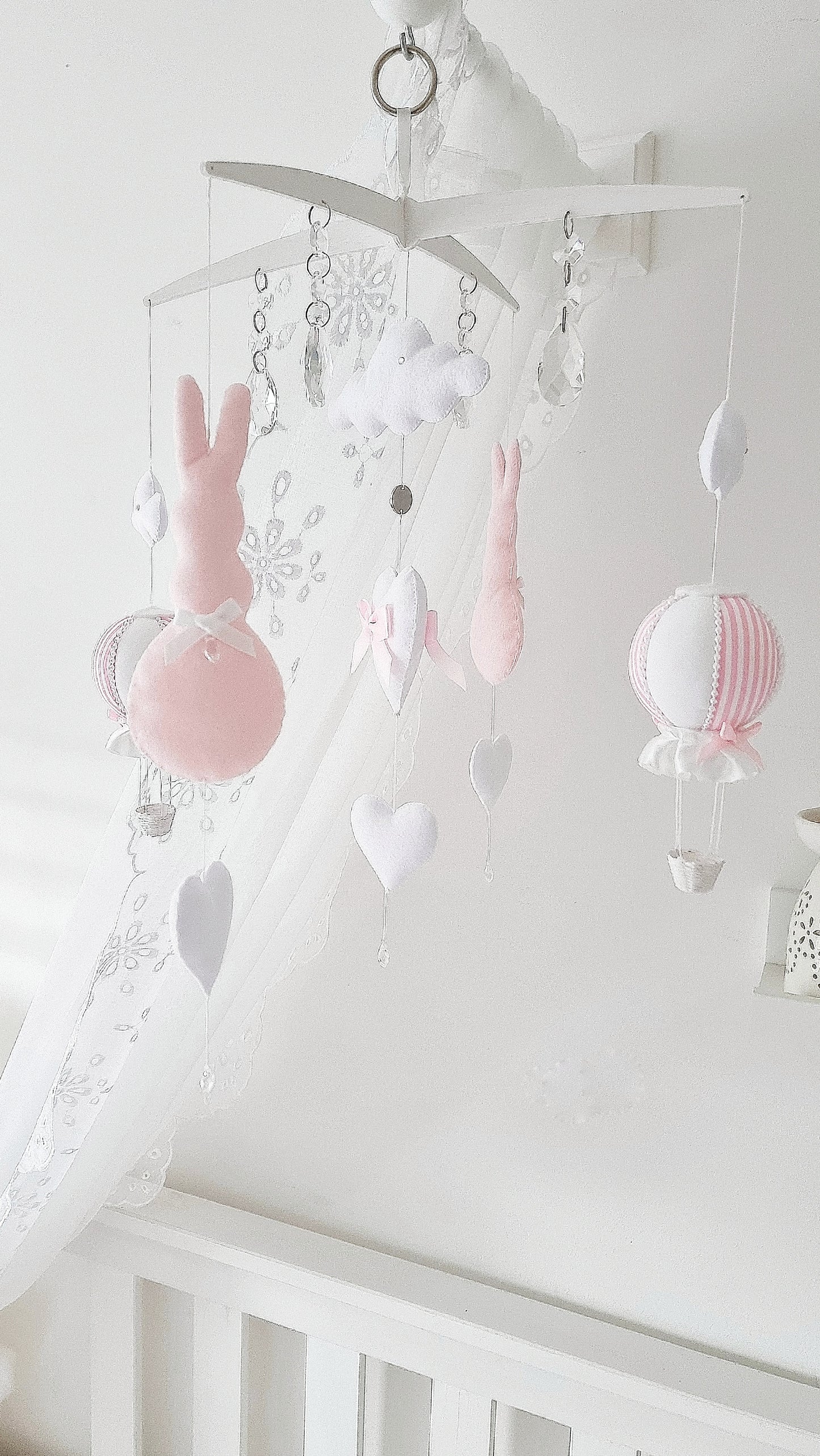 Luxury baby girl mobile with white clouds, blush hearts, and a sweet pink-and-white balloon for dreamy nursery décor.