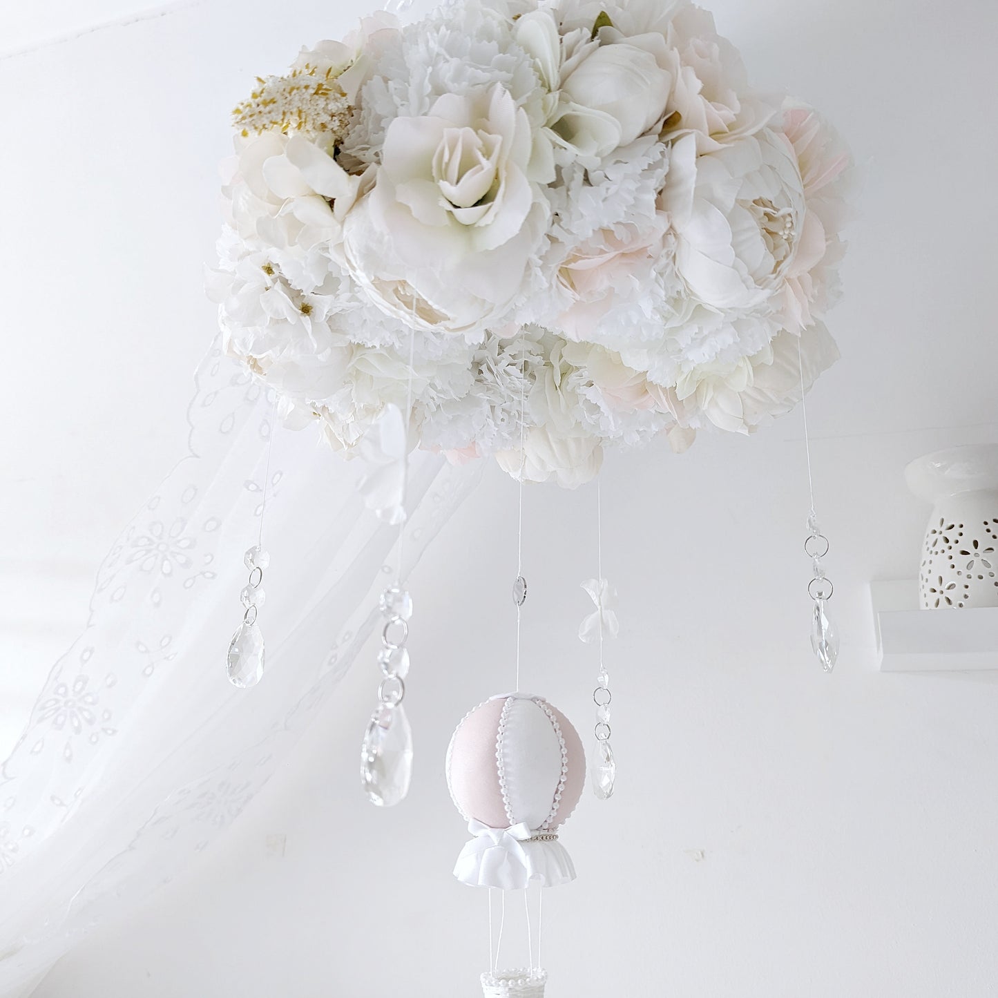Hanging baby mobile with crystal accents, handcrafted florals, and a single blush balloon—luxury nursery decor.