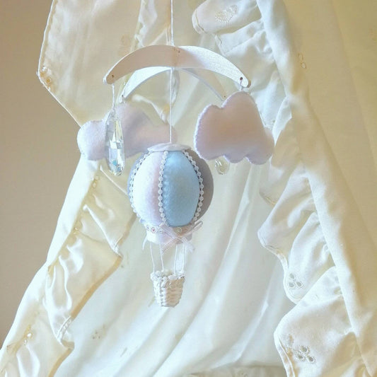 Mini baby mobile featuring pale blue and grey hot air balloon with cloud details, delicately handcrafted for newborn moses baskets. Luxury and exclusive