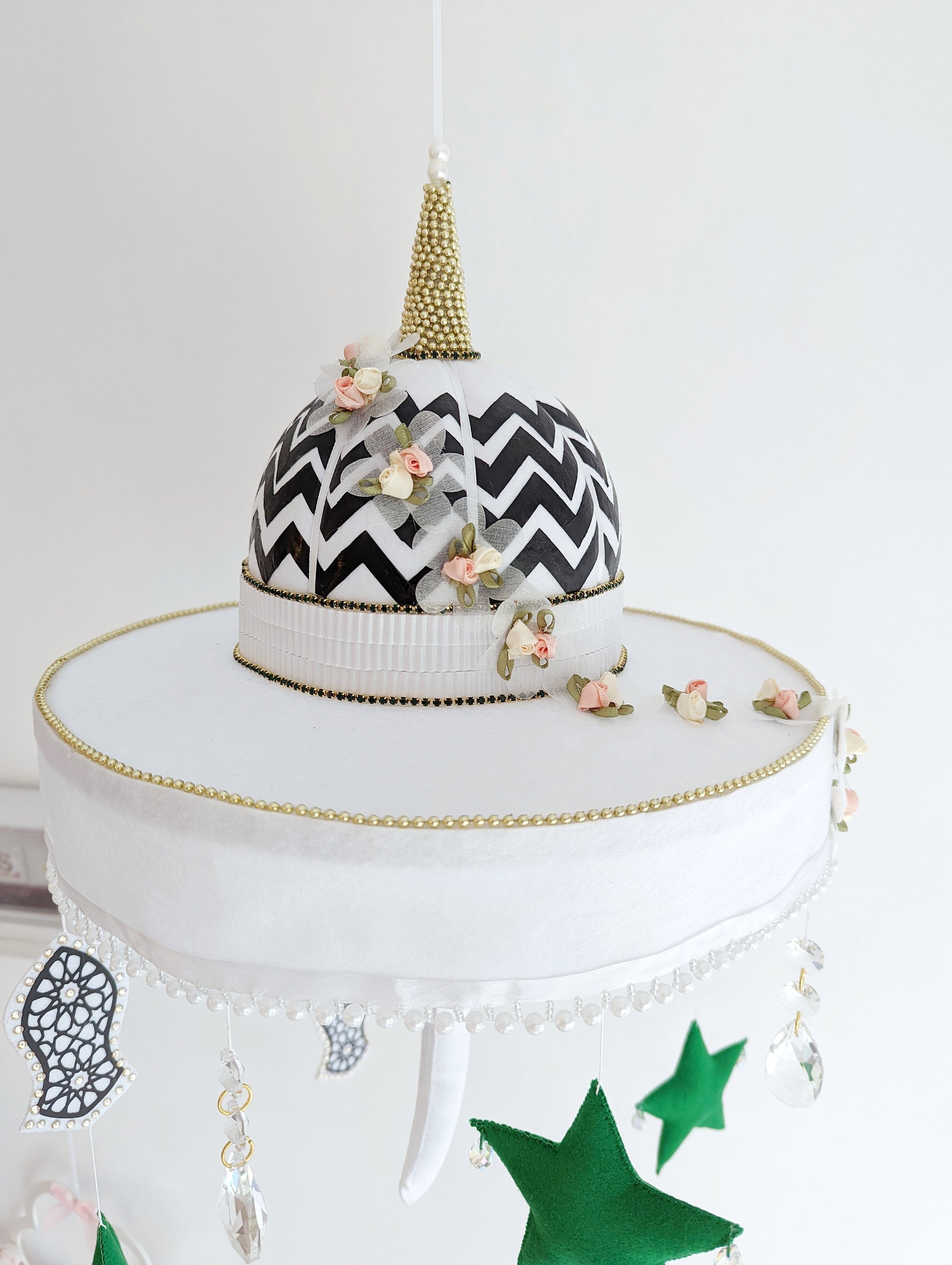 Muslim baby mobile with a black and white patterned mosque dome, crystal drops, and the Sandal of the Prophet Muhammad (pbuh).