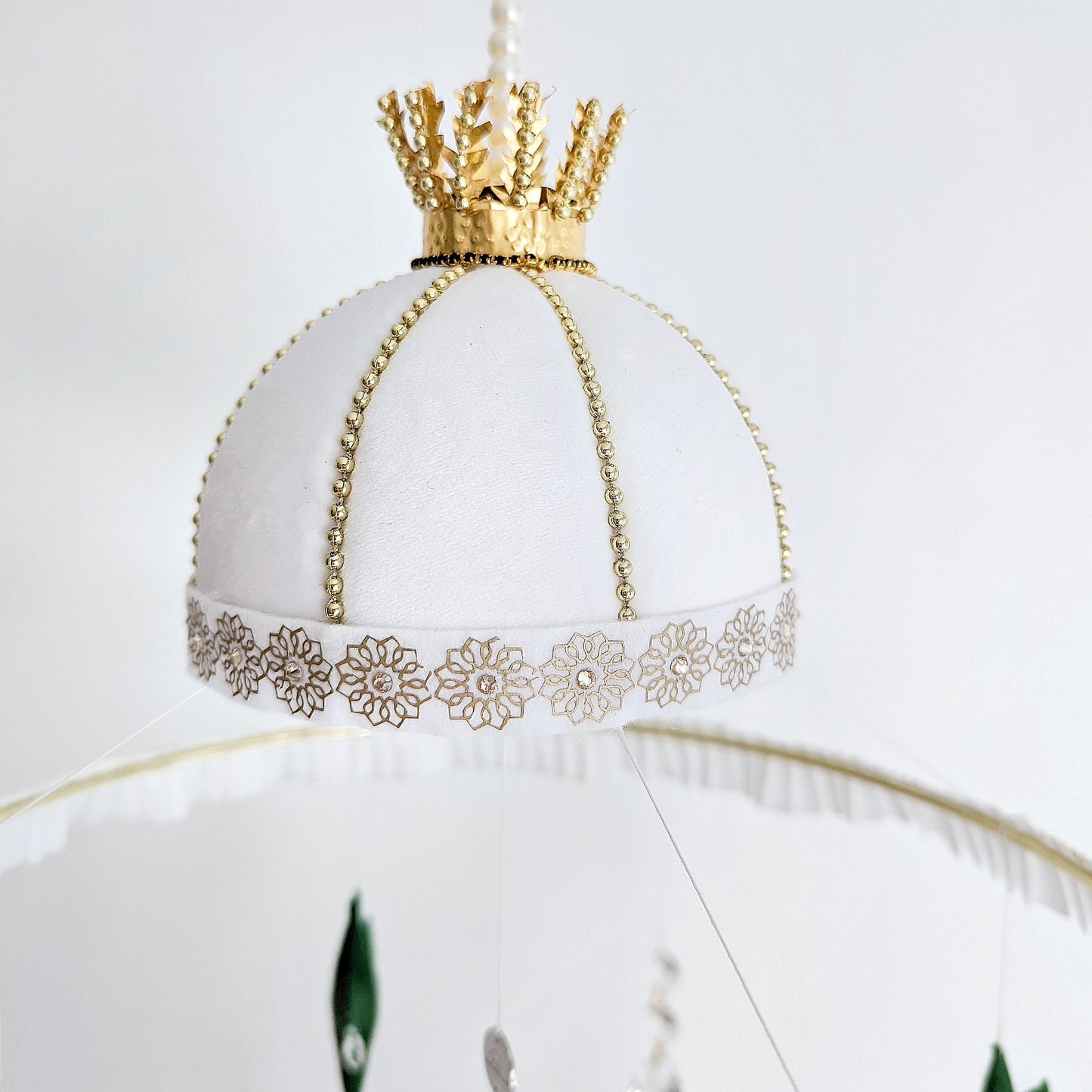 Muslim nursery mobile with delicate mosque outlines and a symbolic representation of the Sandal of the Prophet Muhammad (peace be upon him).