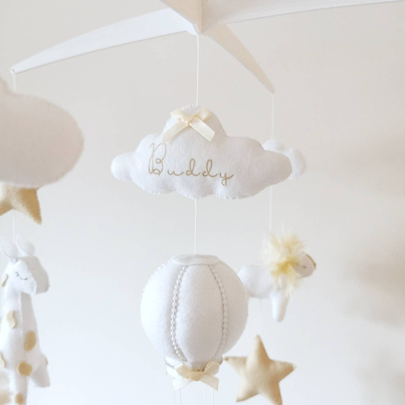 Dreamy handmade nursery mobile in soft neutral tones, with gentle shapes that bring calm and magic to any baby space.