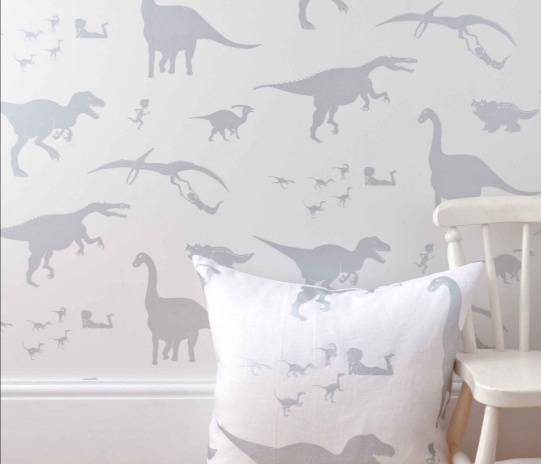 Dinosaur-themed nursery wallpaper in grey tones featuring the same dinosaur style as the handcrafted mobile.