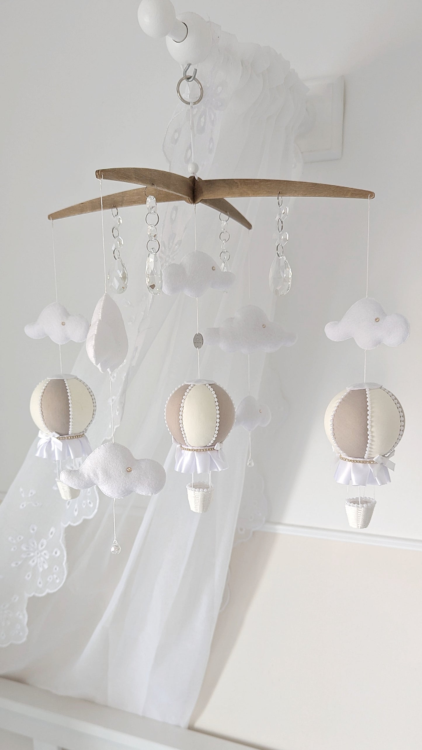 Complete nursery set with coordinating hot air balloon mobile and wall balloons in gentle ivory and taupe.

