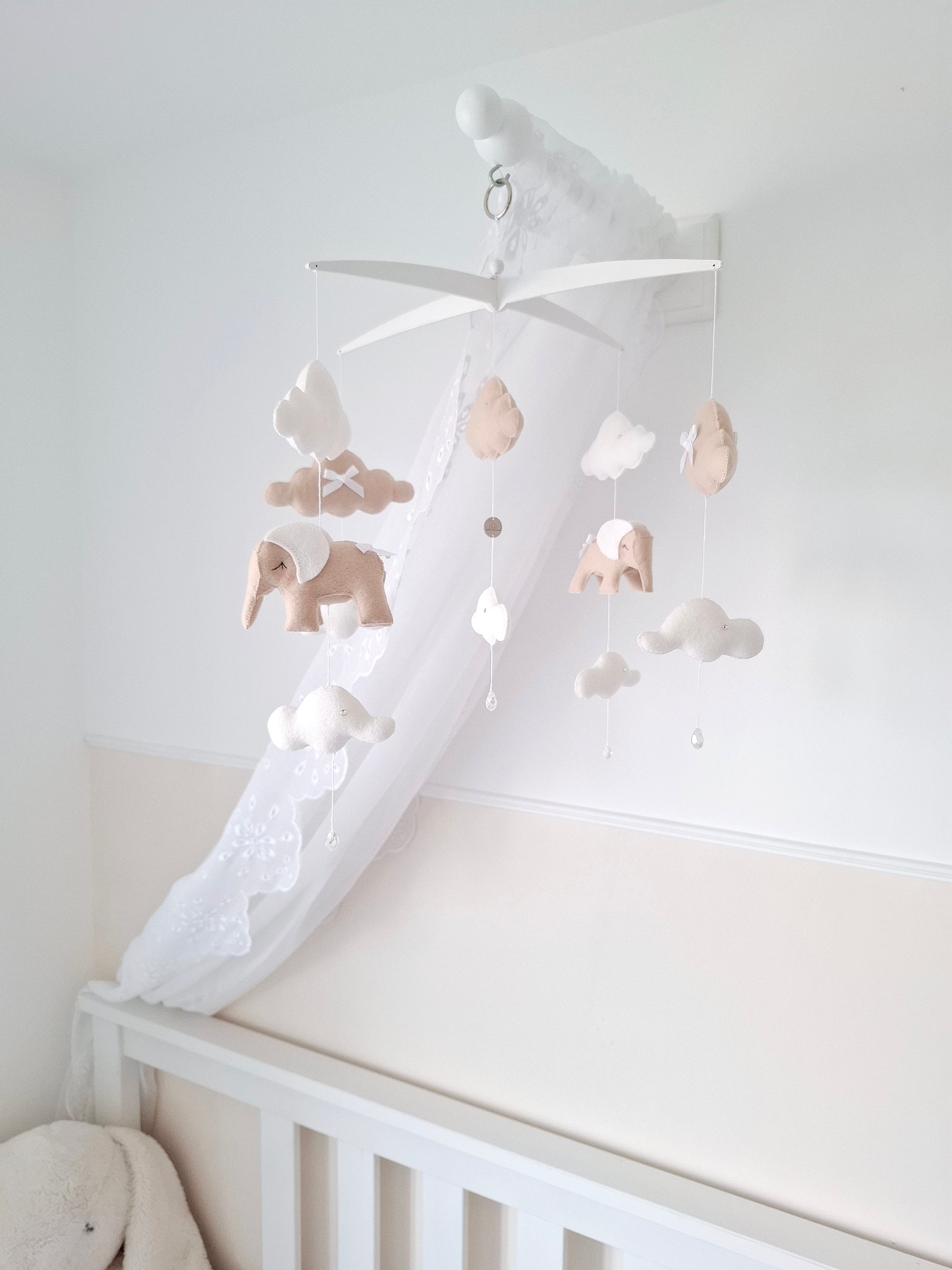  Soft neutral elephant baby mobile shown above a cot, bringing warmth and quiet elegance to the nursery.