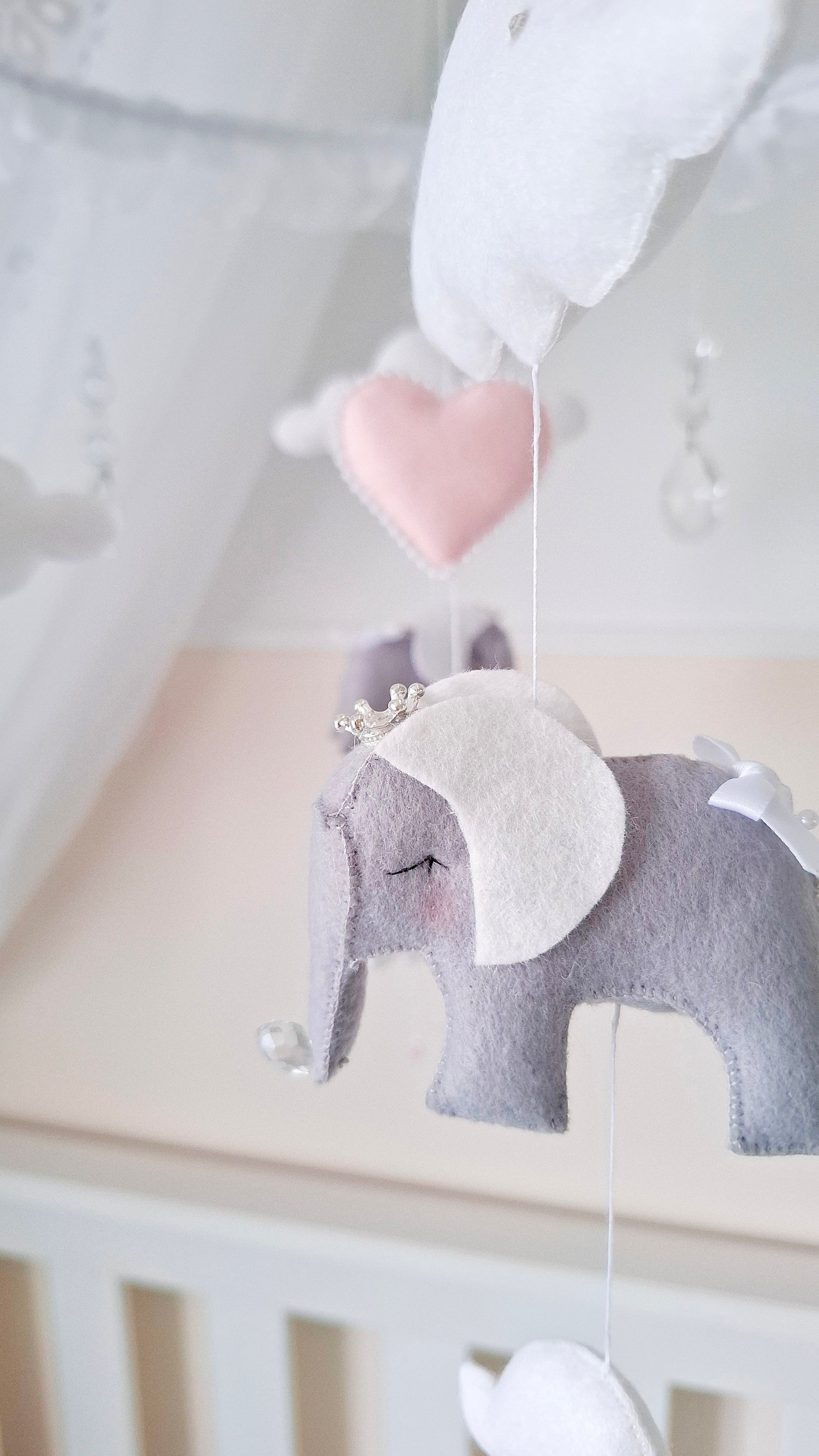  Fairy tale baby mobile with gentle pink and white tones, perfect for an enchanting nursery full of softness and charm.