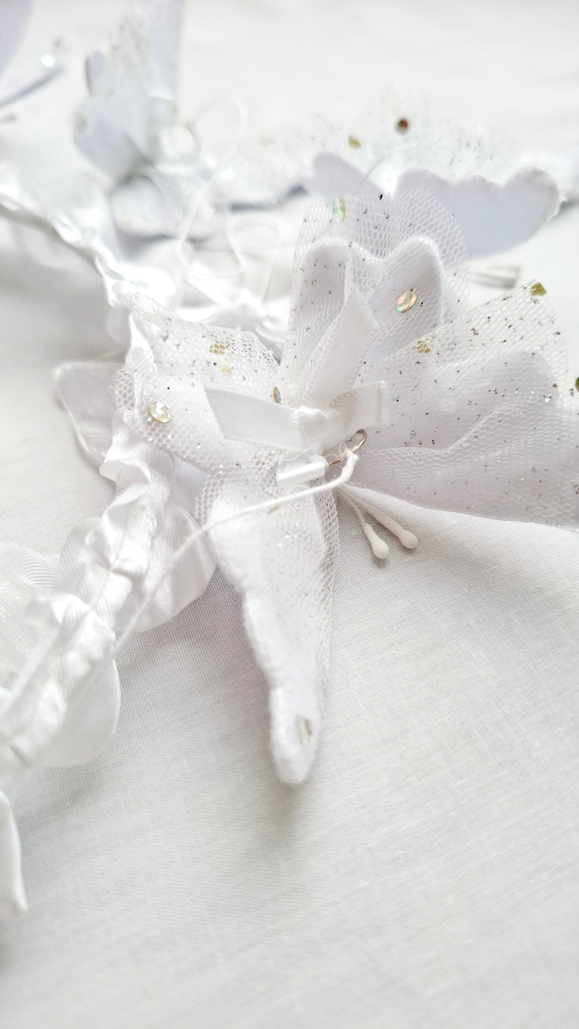 Luxury handcrafted baby mobile with layered white butterflies and intricate lace details, perfect for high-end baby spaces.