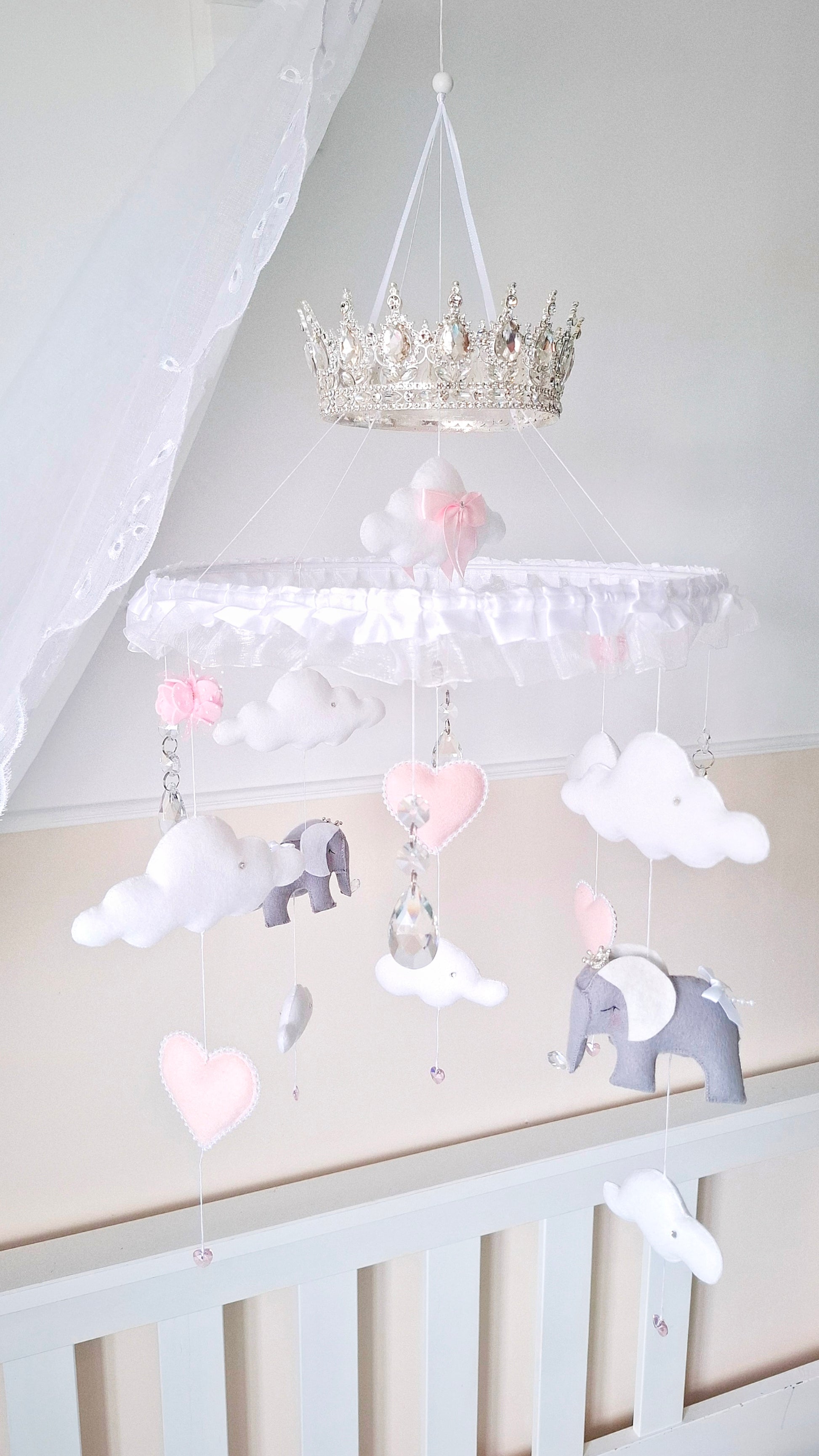 Luxury baby mobile with a silver crown, soft felt elephants, white clouds, and blush pink hearts—fit for a royal nursery.