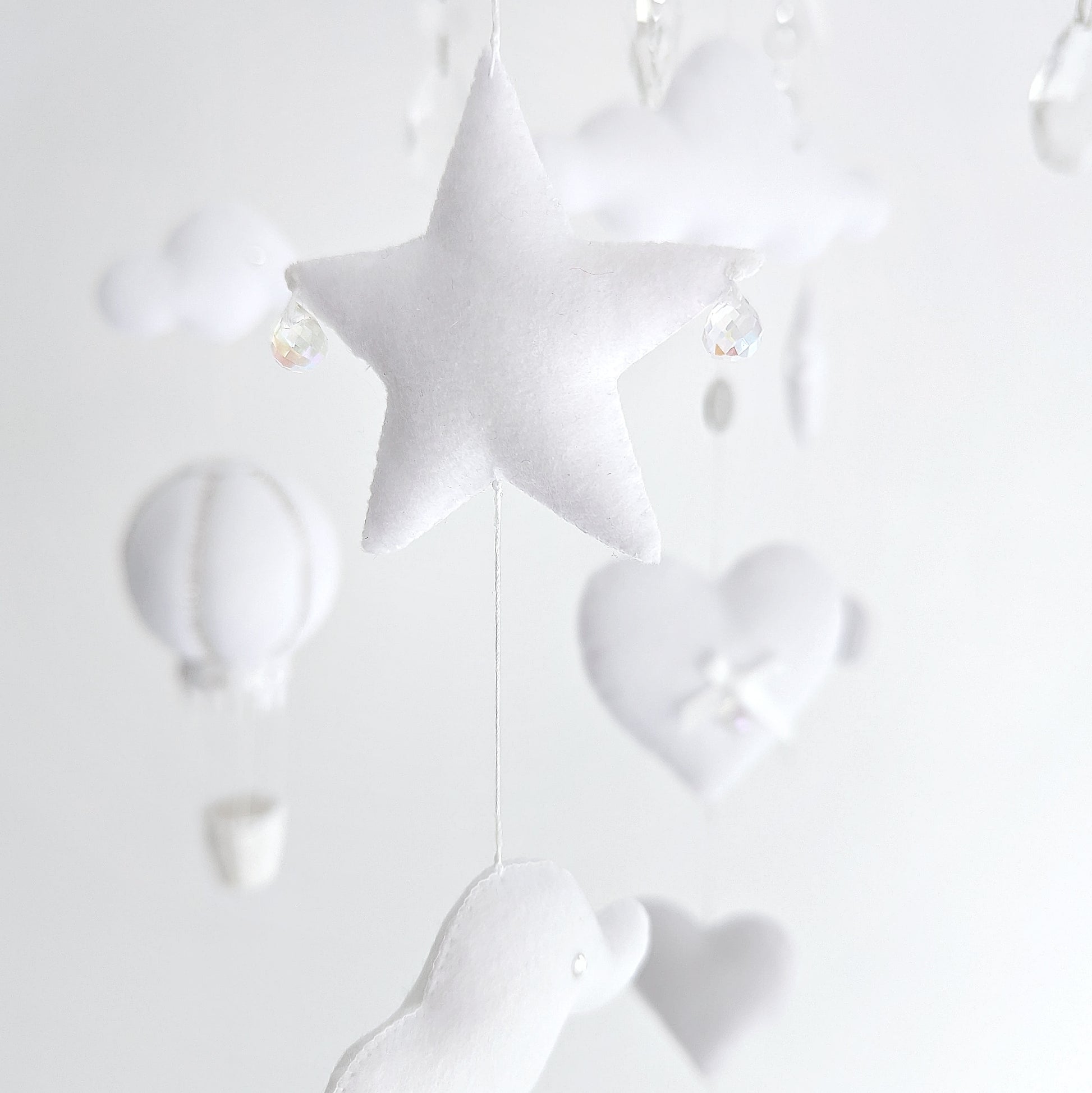 Balloon-themed luxury mobile in soft white, designed with clouds, hearts, and a timeless aesthetic.