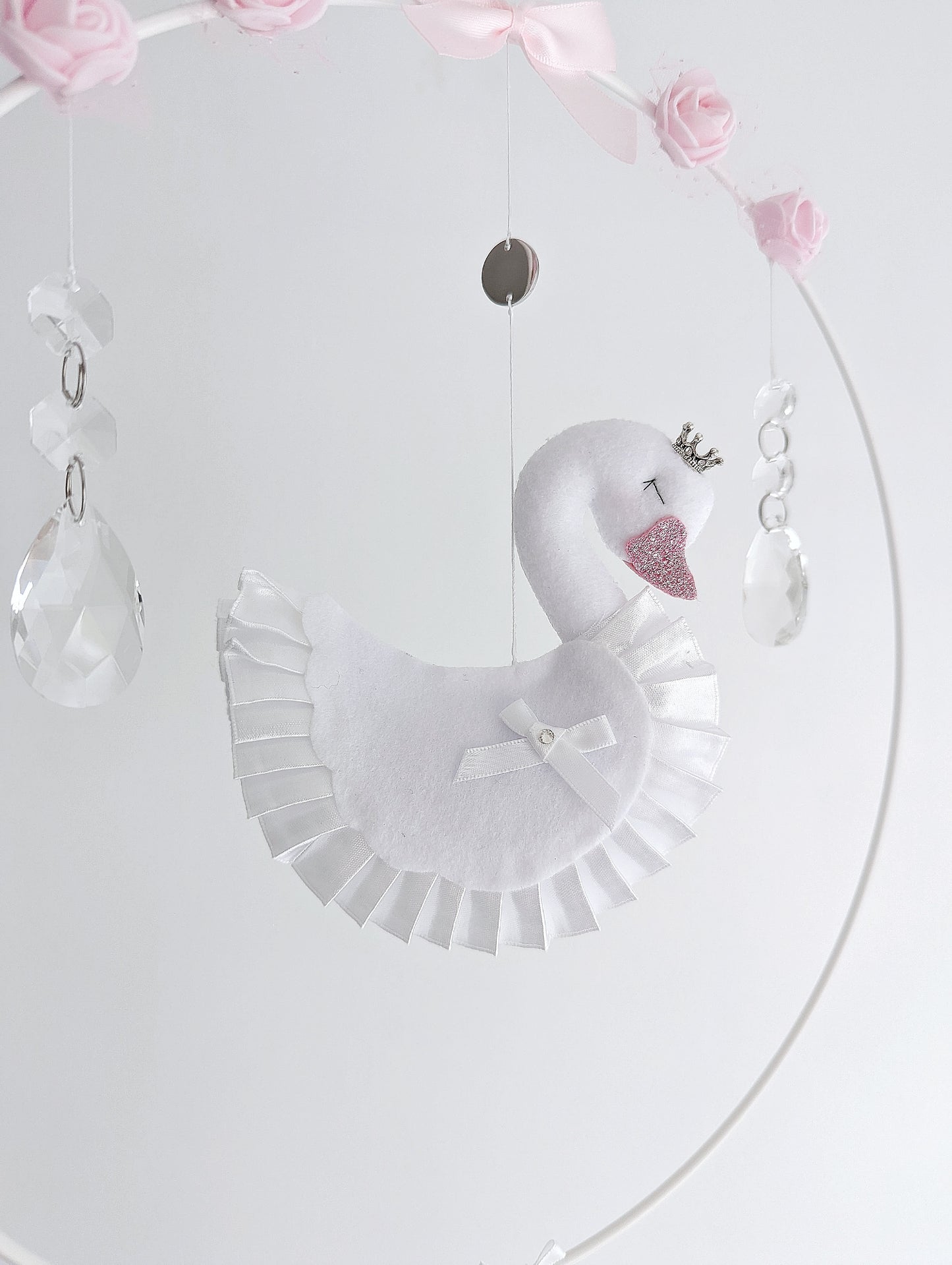 Bespoke swan wall charm with delicate floral garland and soft felt hearts in pink and white.