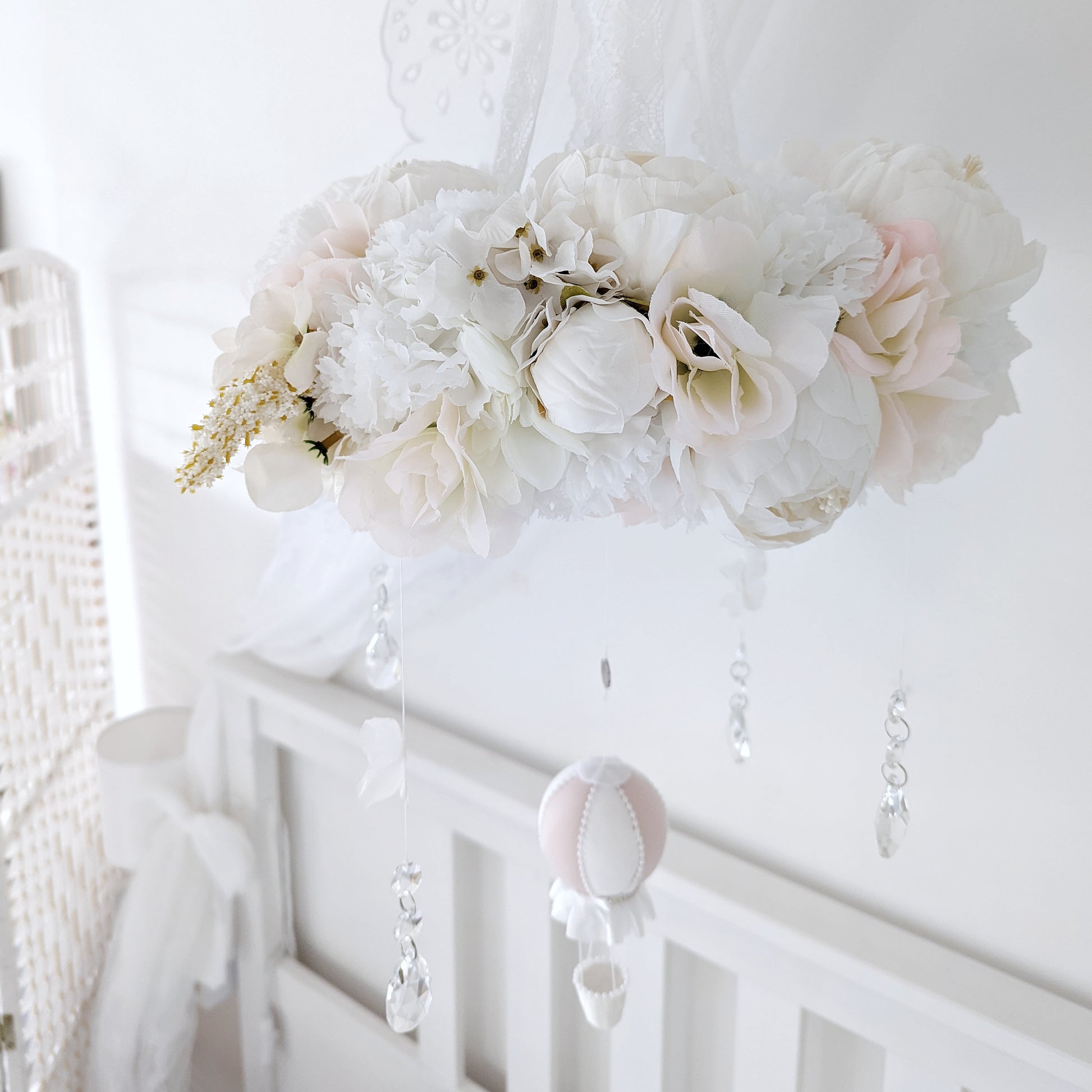 Botanical-inspired mobile featuring delicate pink balloon, ivory florals, and whimsical crystal drops.

