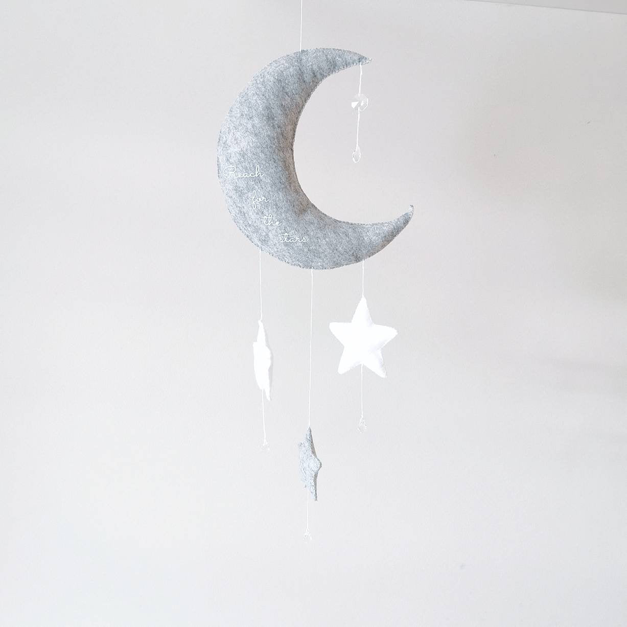 Crescent moon nursery wall décor with hanging stars—lovely as a gift for a christening or new arrival.
