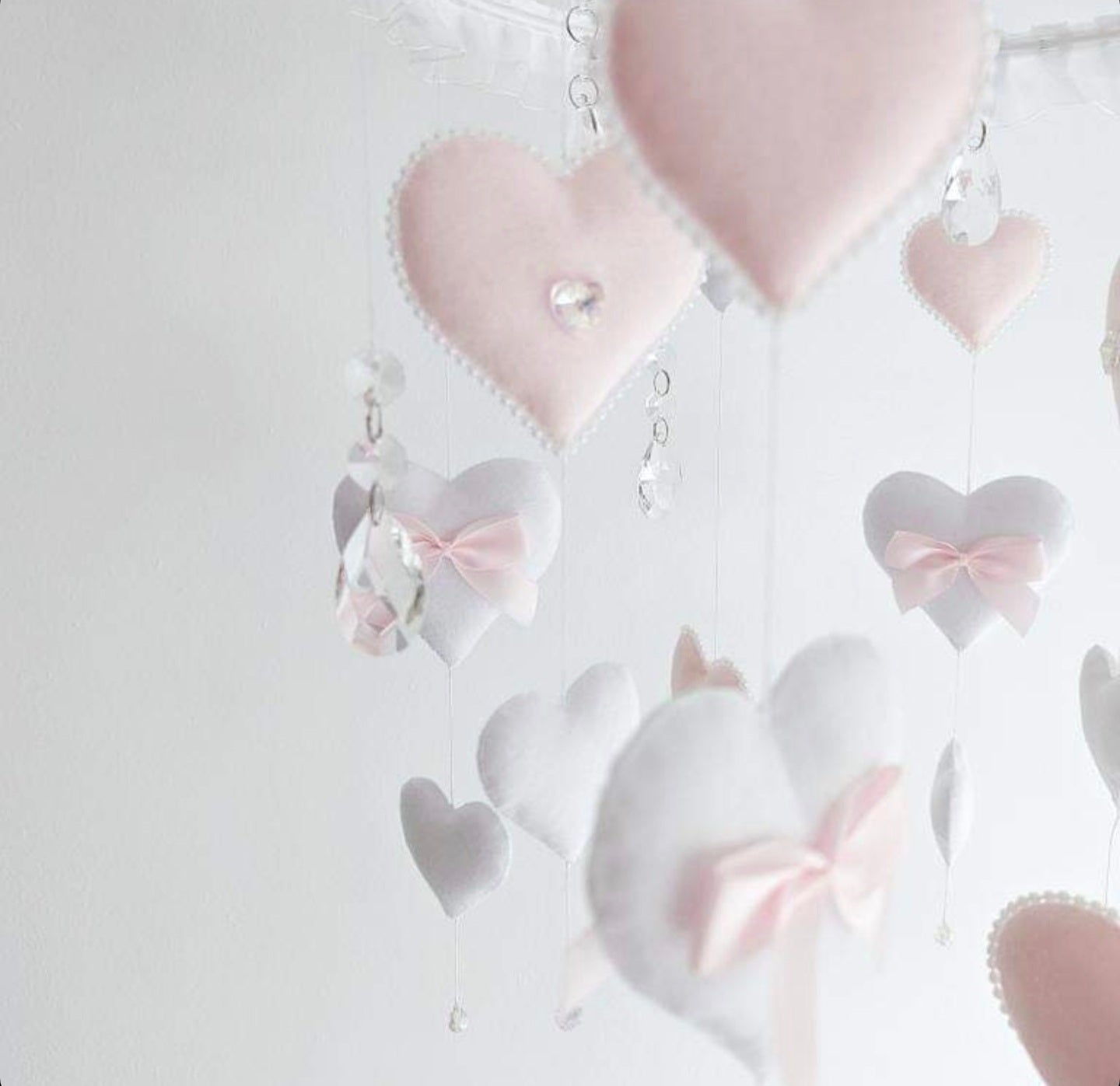 Elegant blush and white baby girl heart mobile with luxury details including a tiara-like crown and delicate hanging crystals.