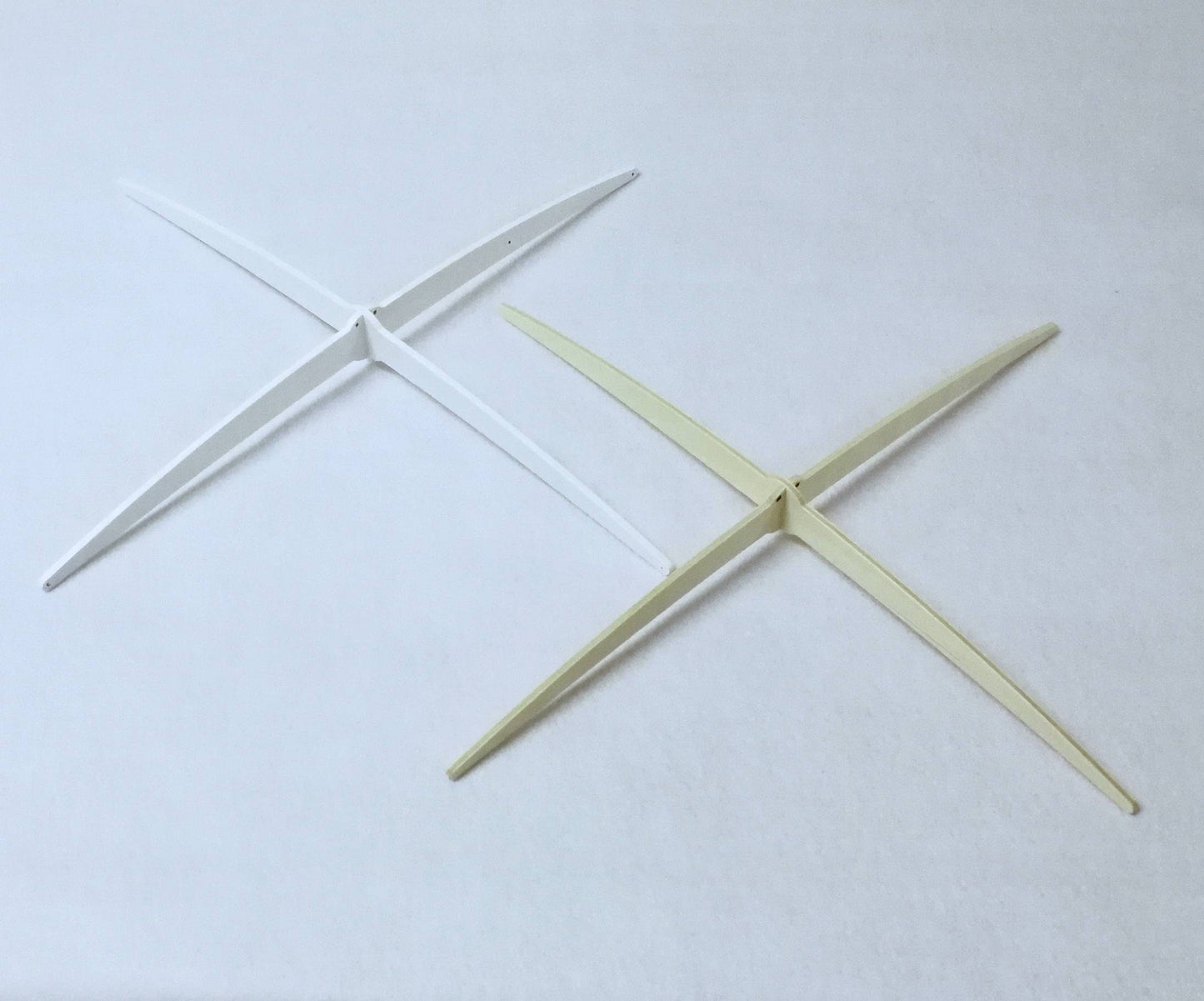 Exclusive white wooden cross-style hanger designed by Happy Little Cloud, used for all artisan baby mobiles.

