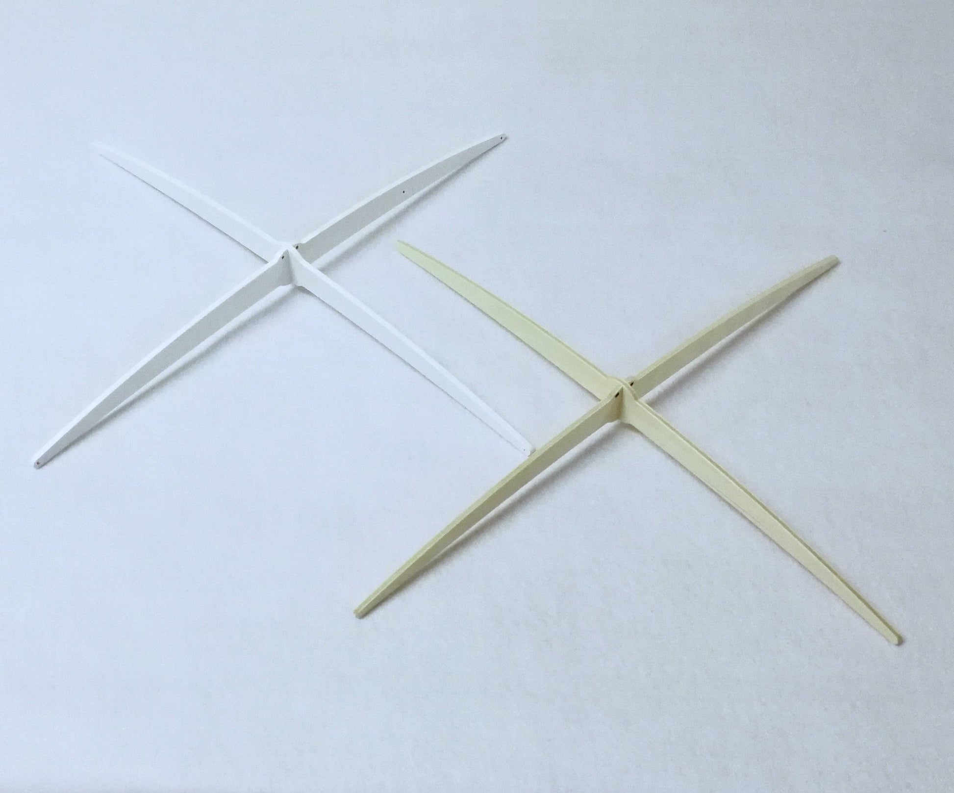 Exclusive white wooden cross-style hanger designed by Happy Little Cloud, used for all artisan baby mobiles.


