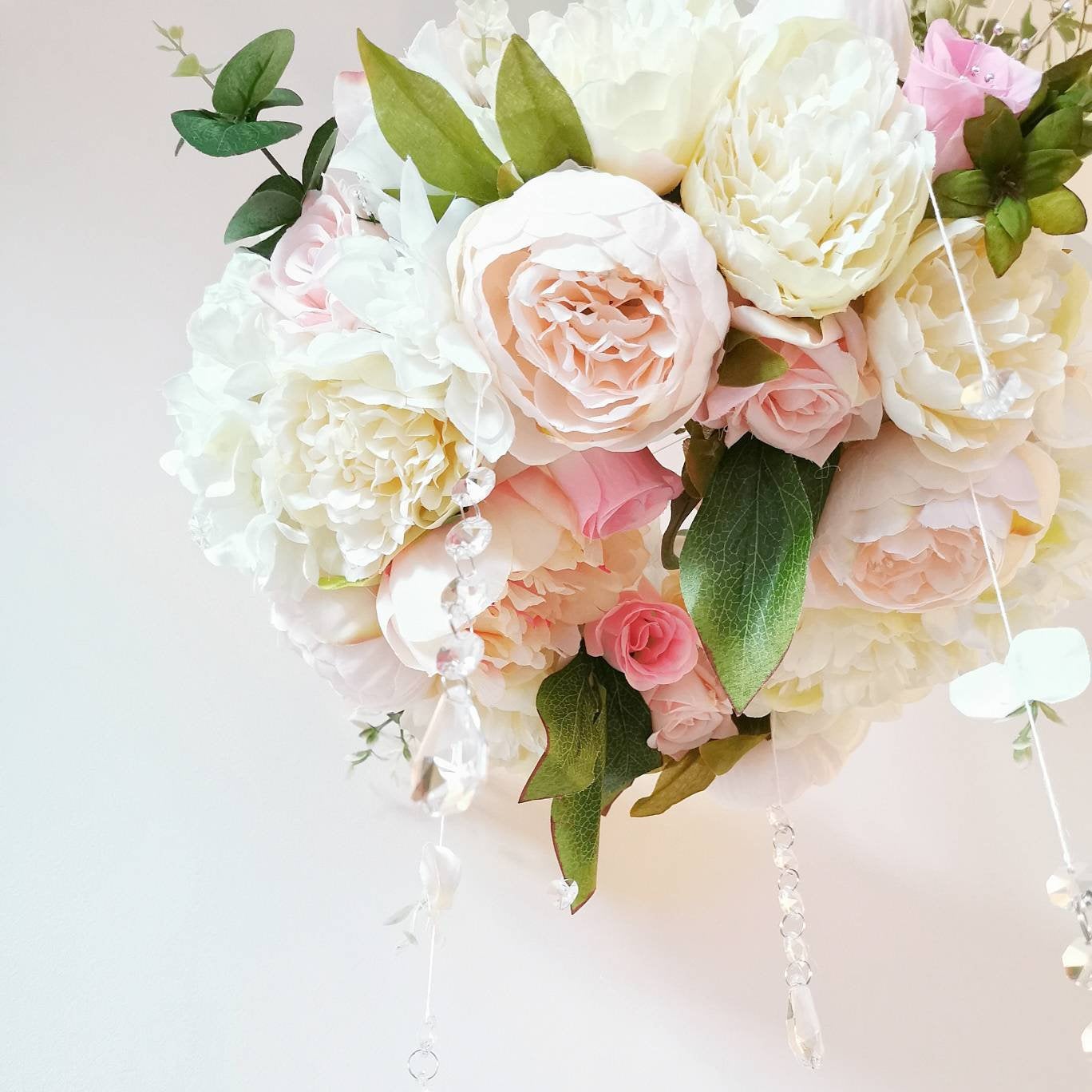 Handmade baby girl mobile featuring lush florals, pearls, and a tiny balloon with trailing greenery.