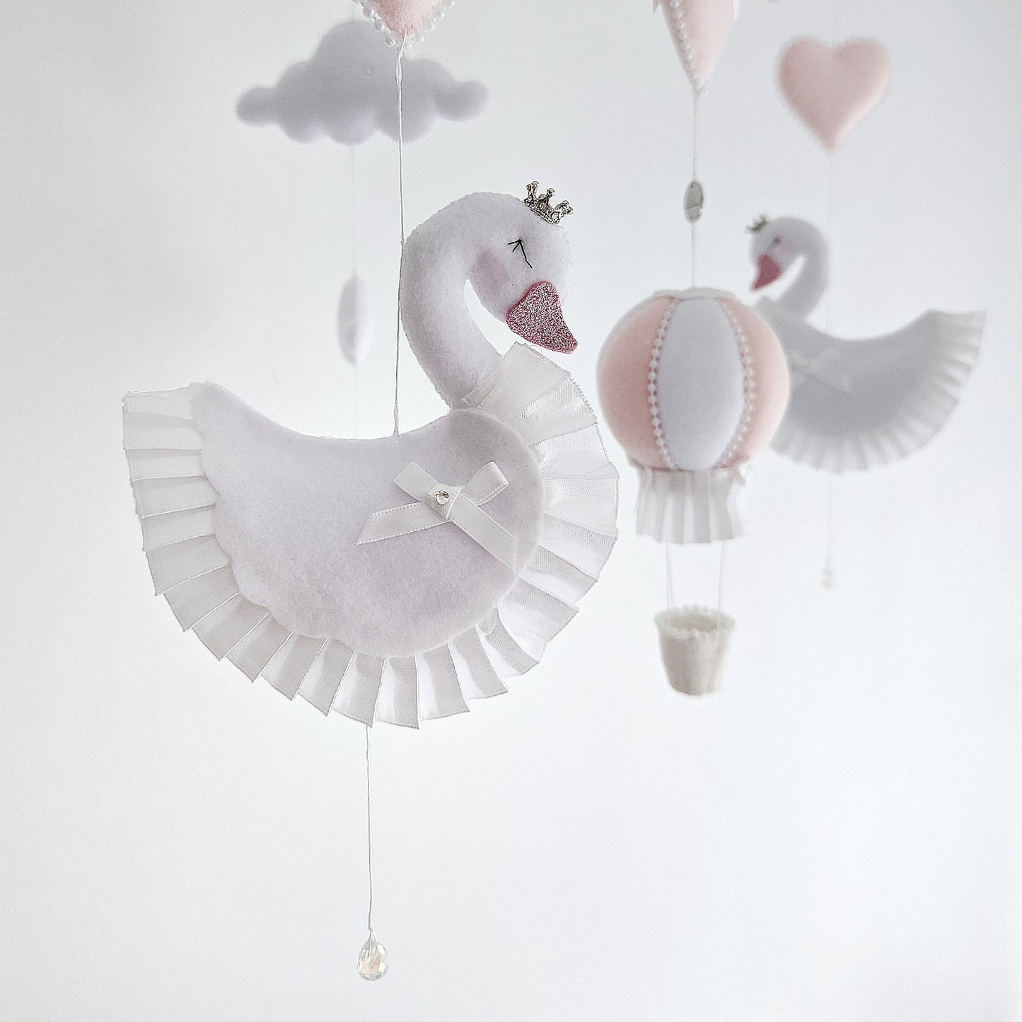 Handcrafted swan mobile with cloud and heart details, perfect for a serene and graceful nursery