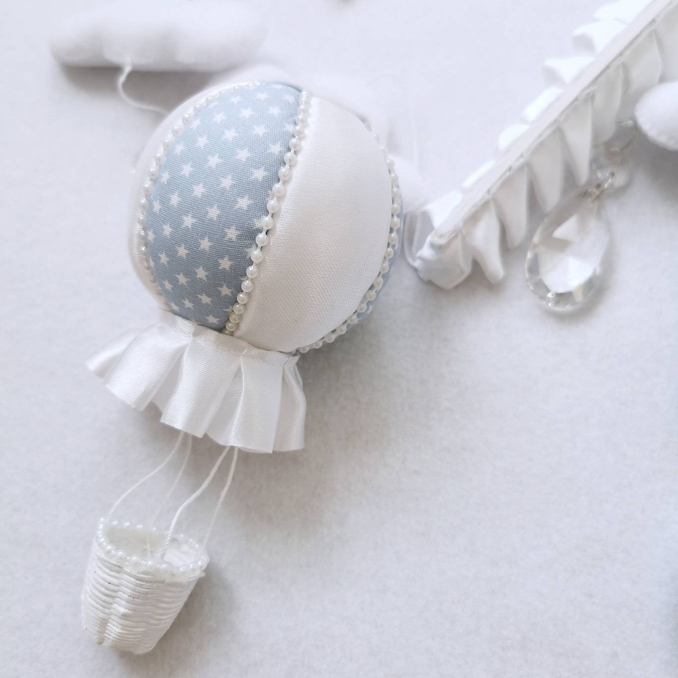 Heirloom-quality felt balloon in soft blue with white stitching, part of a luxury baby mobile set.