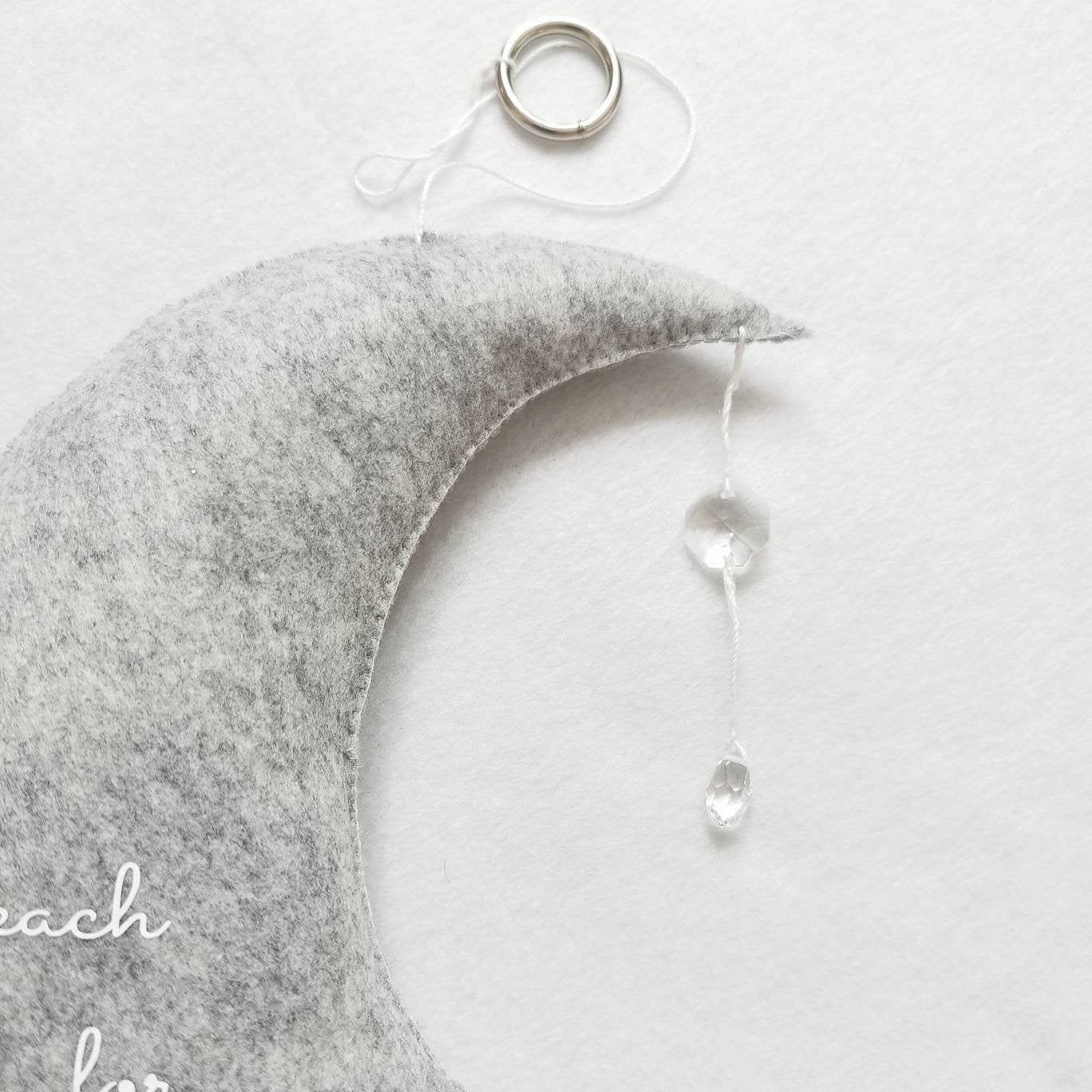 Heirloom-quality felt moon mobile with embroidered quote and stars—thoughtful for baby showers or naming day gifts.