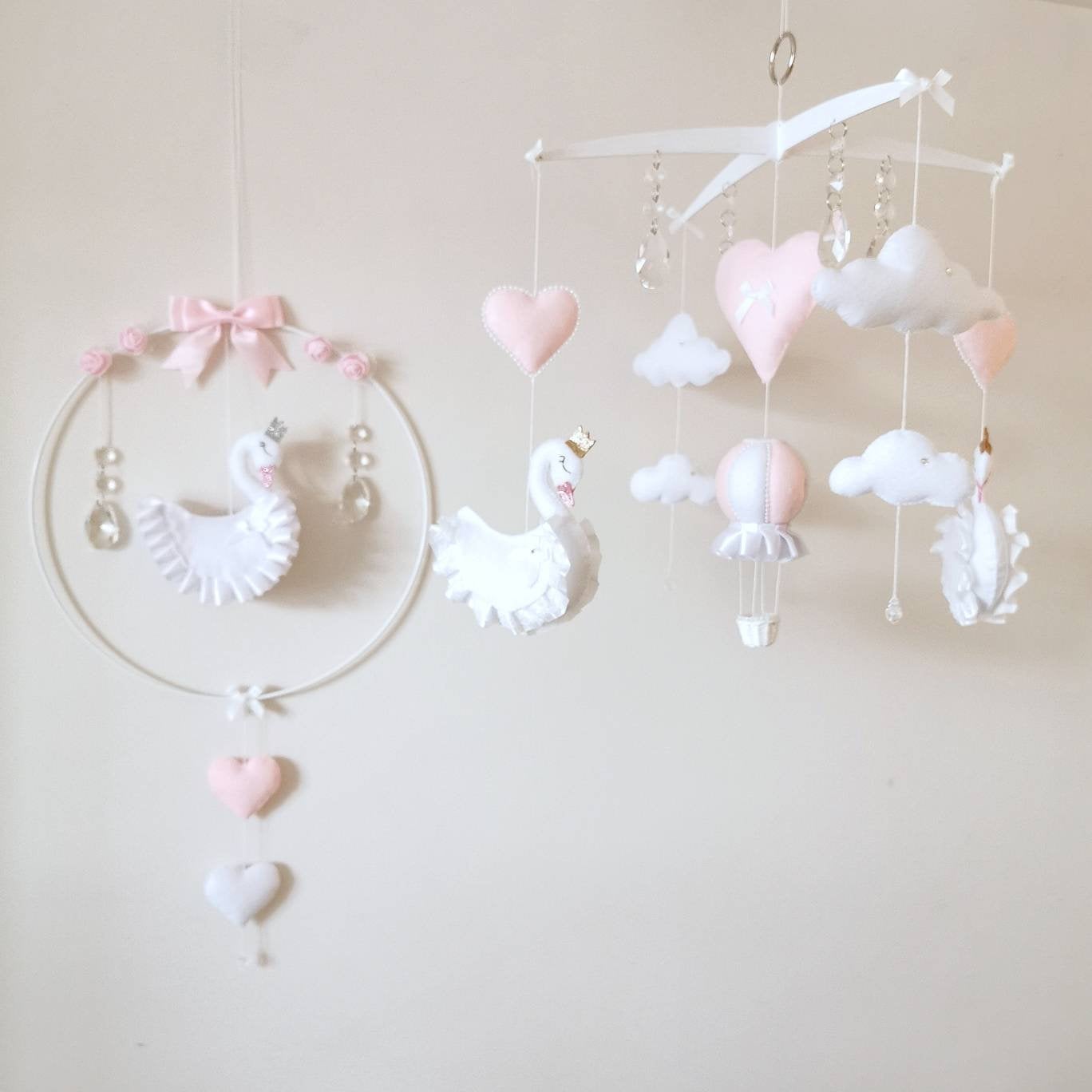 Boutique handmade baby mobile with swans and soft blush accents, a timeless nursery gift.