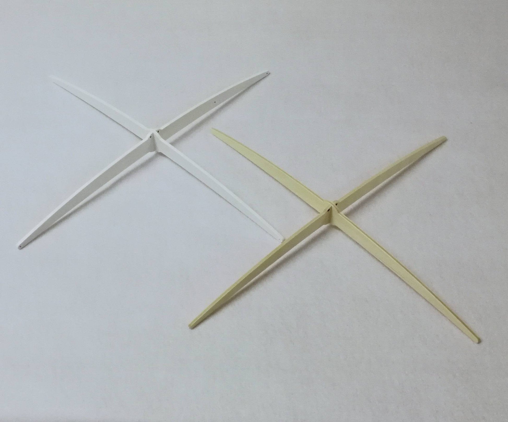 Exclusive white wooden cross-style hanger designed by Happy Little Cloud, used for all artisan baby mobiles.

