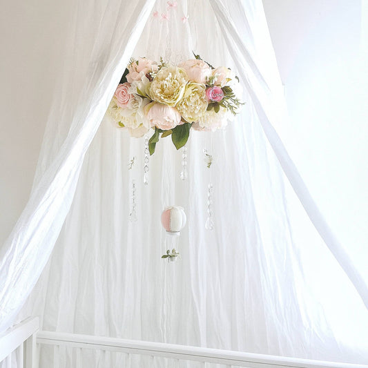 Luxury baby mobile with blush and ivory florals, crystal drops, and a single soft pink hot air balloon.