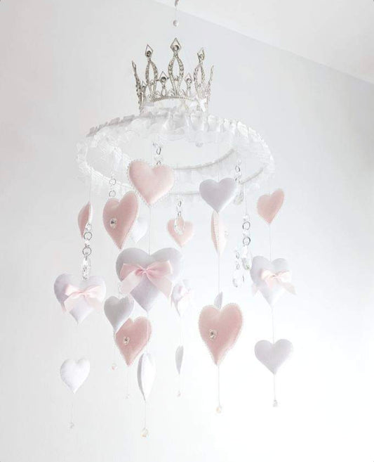 Luxury baby mobile with soft blush and white hearts, crystal accents, and a glittering crown on top.