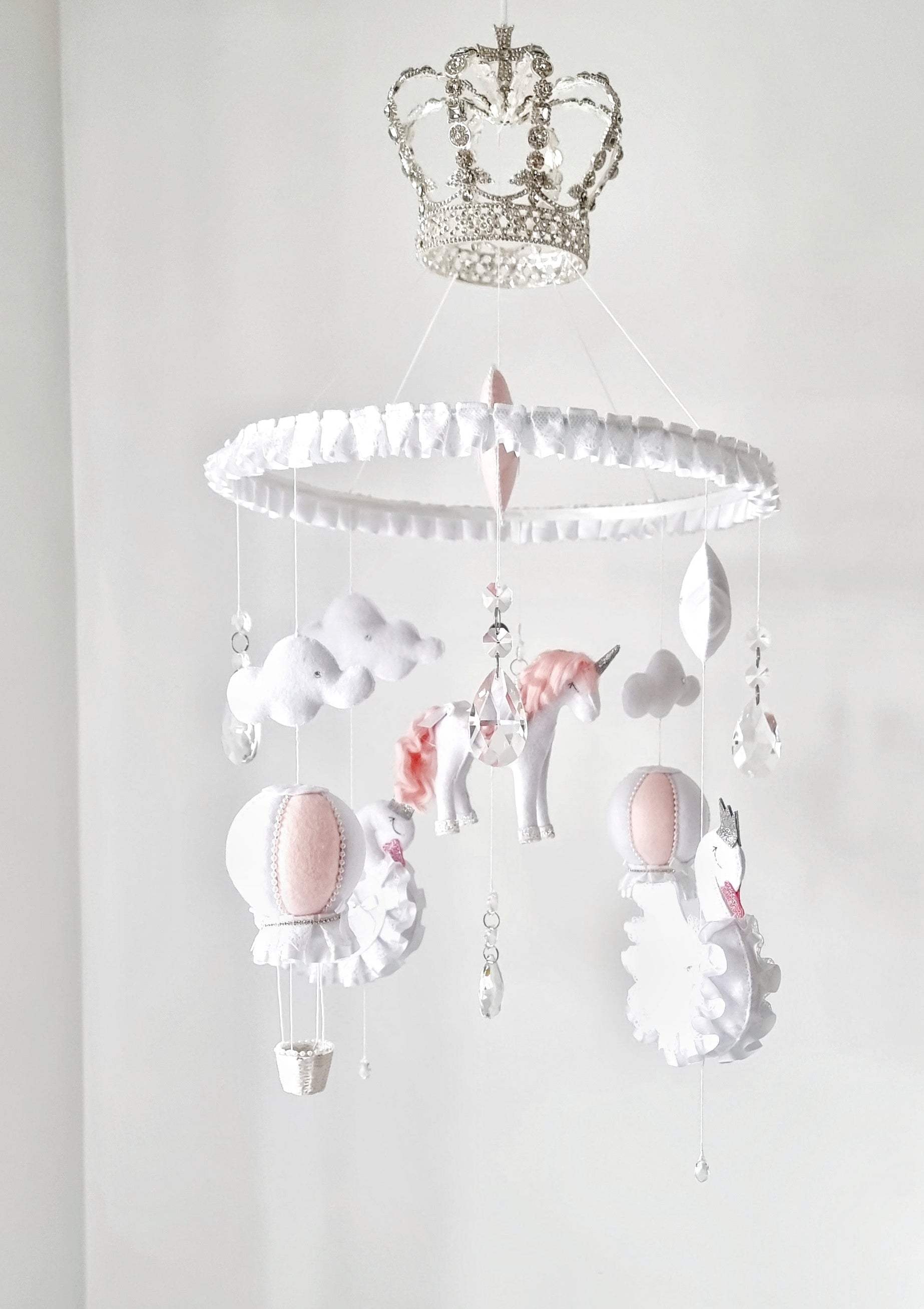 Luxury baby mobile with a sparkling crown, hand-stitched unicorn, and soft clouds, designed for a fairy tale-inspired nursery.

