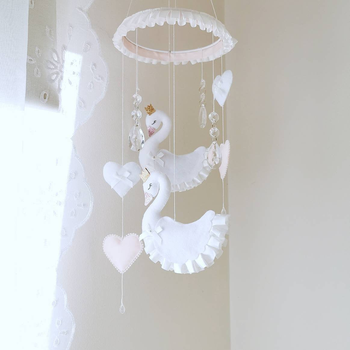 Luxury white swan mobile with crystal accents, ruffled wings and soft pink hearts, perfect for a dreamy nursery