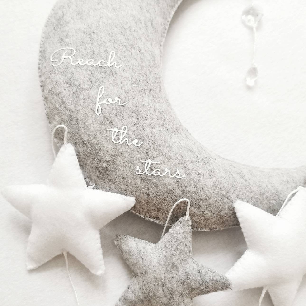 Soft felt nursery wall mobile with moon and stars—an ideal gift for a new born, baby shower, or christening.