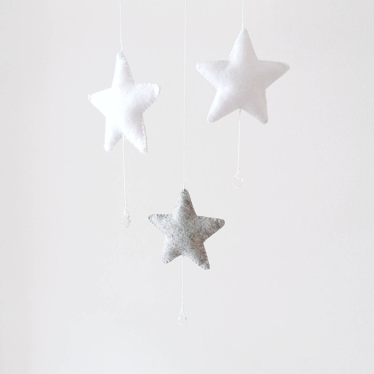 Delicate felt moon and stars mobile with inspirational text—an enchanting baby gift or keepsake.

