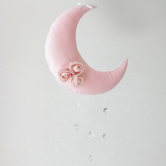 Soft pink crescent moon wall charm with delicate felt roses a gentle and elegant piece for a baby girl’s nursery


