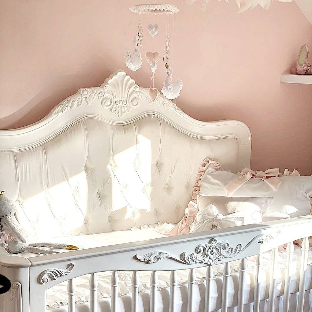 Princess swan baby mobile with white felt swans, ruffle detail, and pink heart accents, ideal for a baby girl's room.