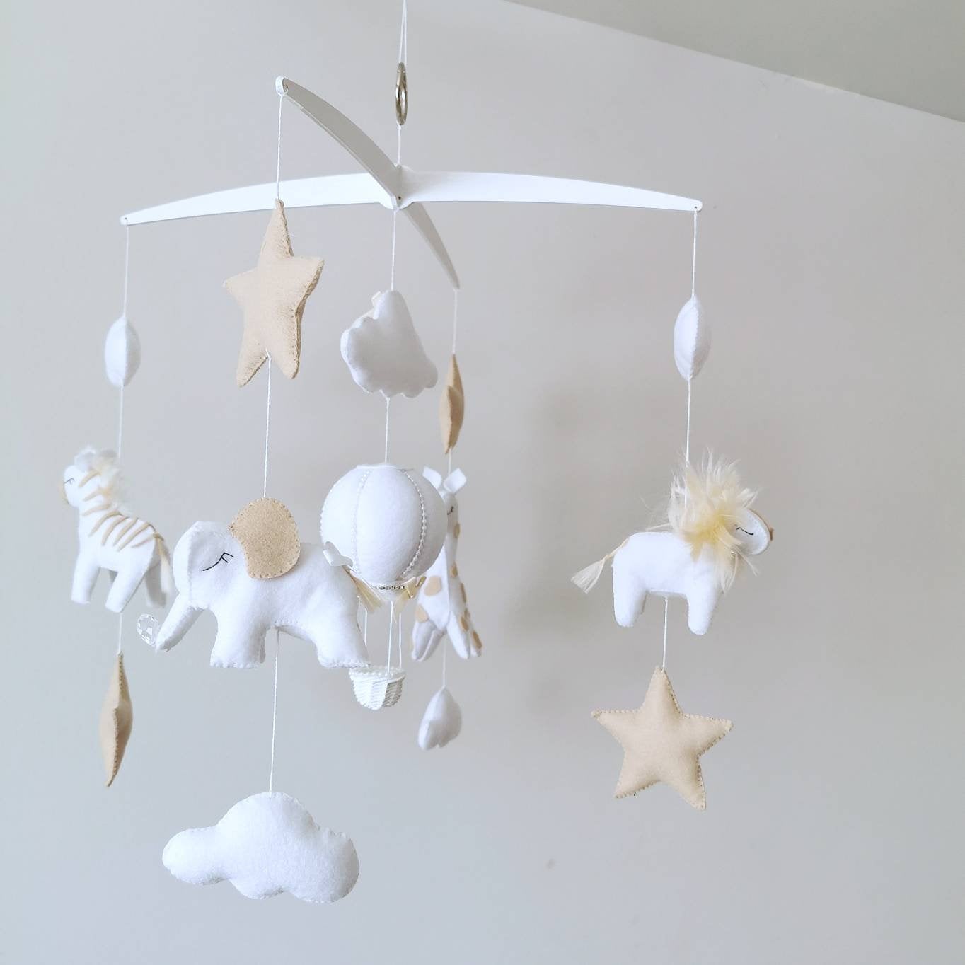 A magical baby gift idea this soft, safari-inspired mobile brings warmth, imagination, and quiet beauty to any nursery.